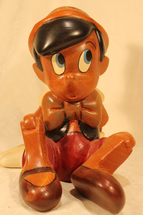 Walt Disney "Pinocchio" Wood Statue: Walt Disney "Pinocchio" Wood Statue. Walt Disney "Pinocchio" carved wood statue. size is 10.75" tall
