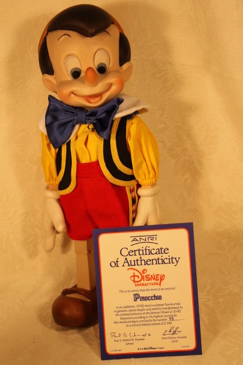 ANRI Wood Sculpture 13.50" Tall Pinocchio: ANRI Wood Sculpture 13.50" Tall Pinocchio. Pinocchio 13" jointed wood figure doll autographed with Mark Mitchell Ohilib & Ulrich Bernardi. Never out of box. LE 49/2500.