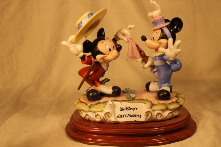 Capodimonte "Nifty Nineties" by Enzo Arzenton,: Capodimonte Disney figure on wood stand, 10x10 depicts Mickey pulling a magical trick.