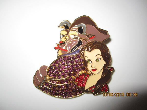 Disney's Beauty & The Beast Brooch Pin: Disney's Beauty & The Beast Brooch Pin. Beauty & Beast done with enamel and purple crystals on Beast's cape, red crystals on Beauty's dress. 2"L x 2"W