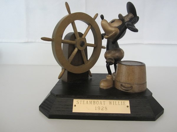 Steamboat Willie Wooden Figurine by ANRI: Steamboat Willie Wooden Figurine by ANRI. Mickey Mouse as Steamboat Willie. Brass plaque says "Steamboat Willie 1928". LE 5/1000, signed by Ulrich Bernardi, ANRI tag on bottom. 1990, 6"t x 5"w, COA
