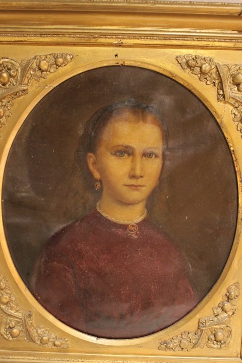 Oil Portrait of a Young Woman: Oval portrait of a young woman with locket, earrings, and ribbon in hair, size is 18 x 15 1/4" frame size is 24 1/4" x 21 3/8"