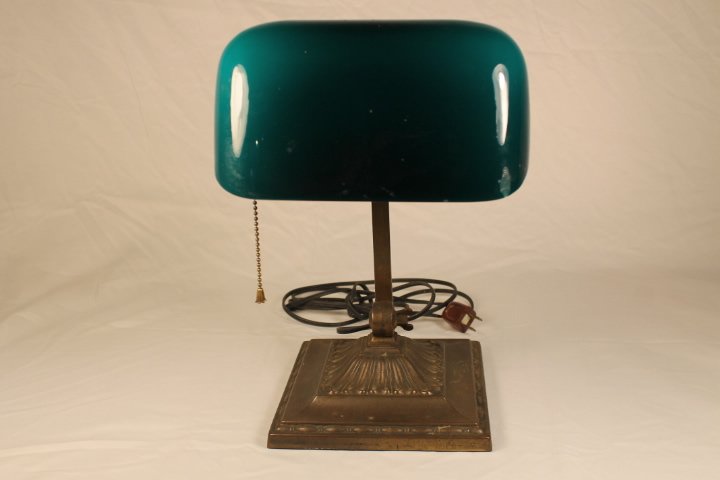 Emeralite Lamp: Desk lamp, brass or bronze, 14" tall by 8" wide case glass shade, has baper decal label on shade
