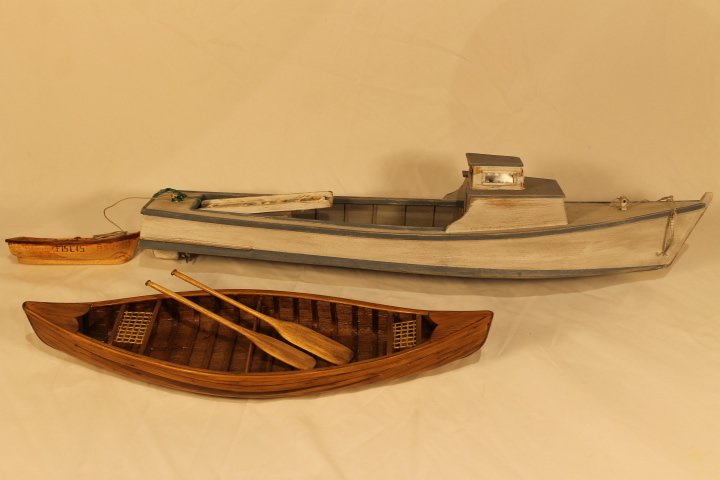 2 Jerry DeGraff boats: 1. Canoe with oars, size is 17 1/2" long 2. Fishing boat 24" long, painted wood Both pieces are hand made and in very good condition