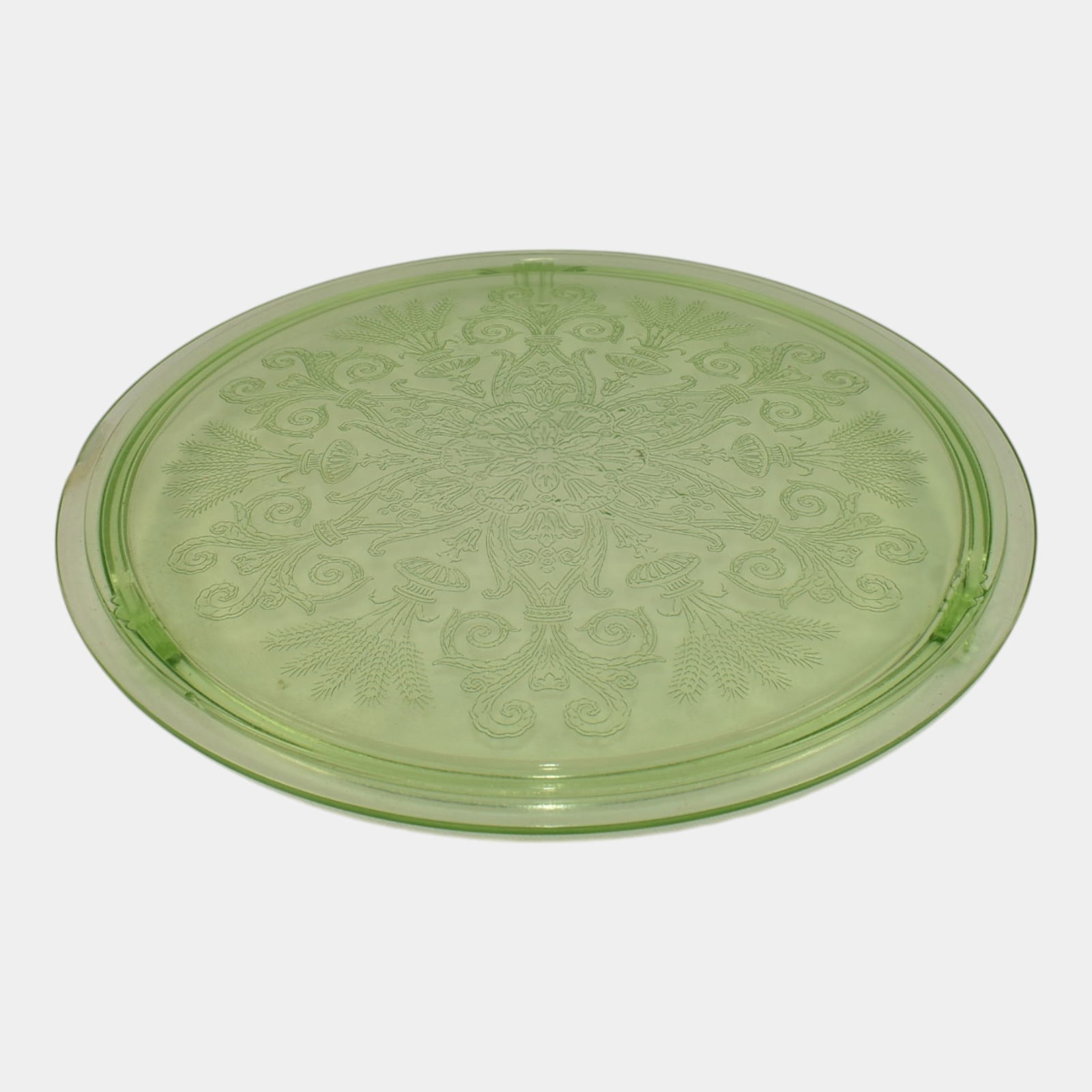 Vintage Uranium Green Glass Round Cake Stand: We offer in house shipping on all items. Plus spend $500 on winning bids and your shipping is free. Vintage Uranium Green Glass Round Cake Stand Small nick to edge. Age related wear.Stand is 1" tall a