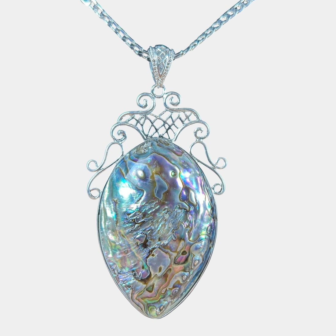 Sterling Silver 30" Chain & Pendant With Large Iridescent Abalone Shell and Decorative Scrollwork: We offer in house shipping on all items. Plus spend $2000 on winning bids on qualified items and your shipping is free. Beautiful sterling silver pendant featuring a large iridescent abalone shell fr