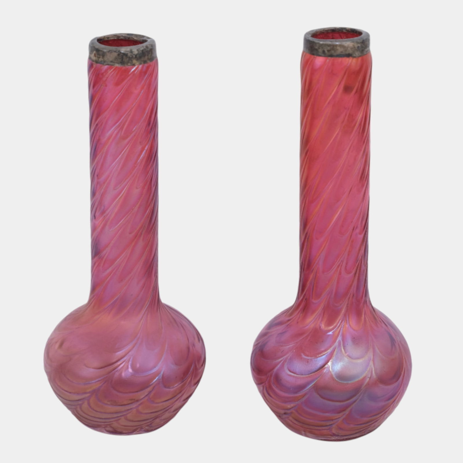 Kralik Bohemian 1900s Iridescent Cranberry Glass Draped Swirl Vases Silver Rims: Kralik Bohemian 1900s Iridescent Cranberry Glass Draped Swirl Vases Silver Rims Elegant Kralik Art Nouveau glass vases featuring elongated necks and swirling feathered decoration. Finished in luminous