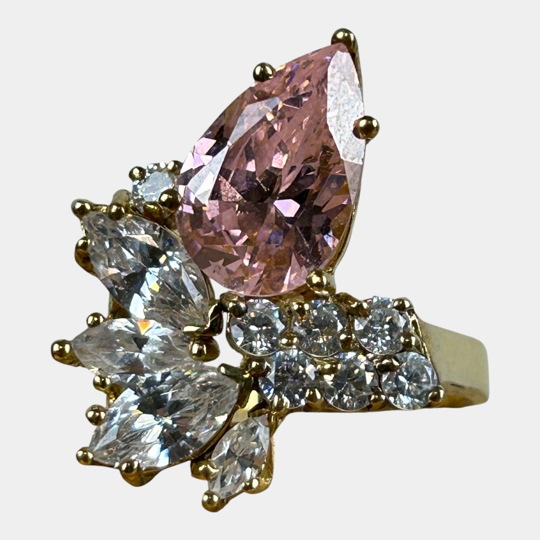 Sterling Silver 925 Pink And Clear Prong Set Stones Statement Ring Size 7: Boldly glamorous and brilliantly faceted, this sterling silver statement ring features a large pear-cut pink crystal accented by clusters of clear rhinestones, set in a sculptural mount with dramatic
