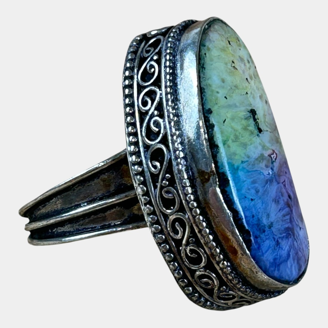 Sterling Silver 925 Elegant Scrollwork Framed Multi-Color Cabochon Ring Size 8.5: Strikingly bold and artfully detailed, this sterling silver ring features a large multicolor cabochon blending blues, violets, and soft greens, framed by ornate scrollwork and beaded edging for a