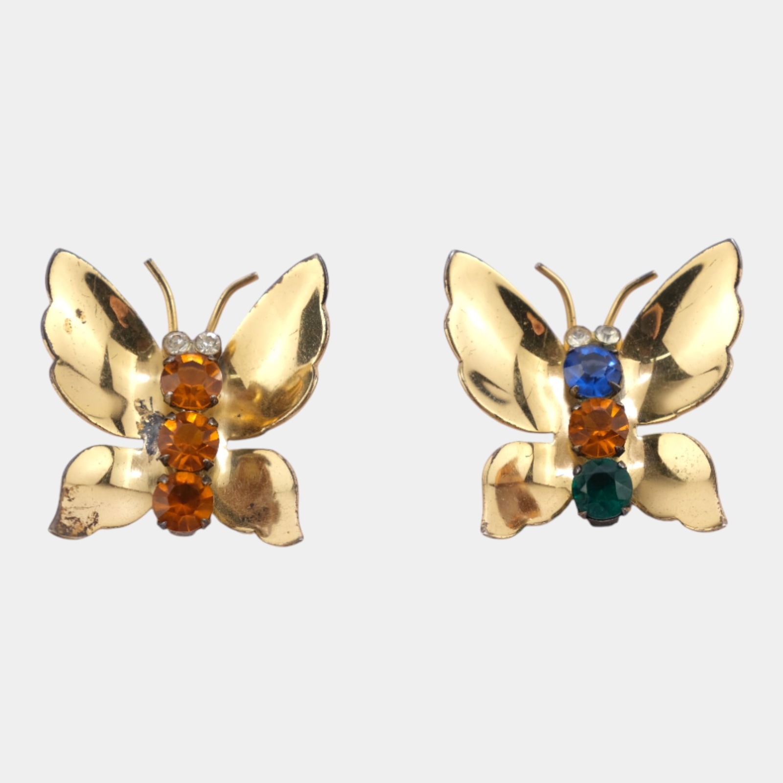 Coro Sterling Silver Gold Vermeil Prong Set Rhinestone Butterfly Brooches: Charming pair of Coro butterfly brooches crafted in gold-tone metal and set with colorful rhinestones. Stylized wings and vibrant stones create a playful Mid Century look, making this matched duo a br
