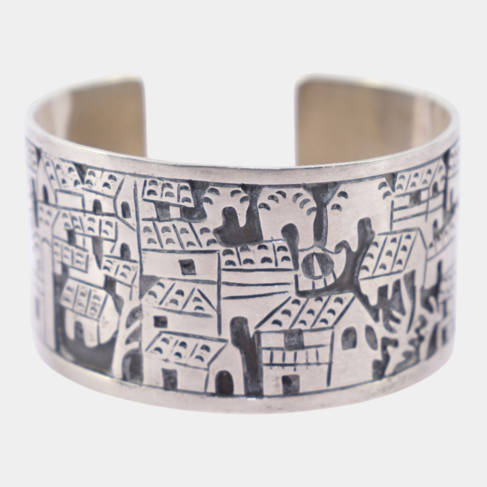 Taxco Mexican Mid Century Sterling Silver Village Storyteller Cuff Bracelet: Bold Taxco sterling silver cuff bracelet featuring an engraved village landscape with stylized buildings and figures. Strongly graphic and architectural, this piece reflects classic mid-century Mexica