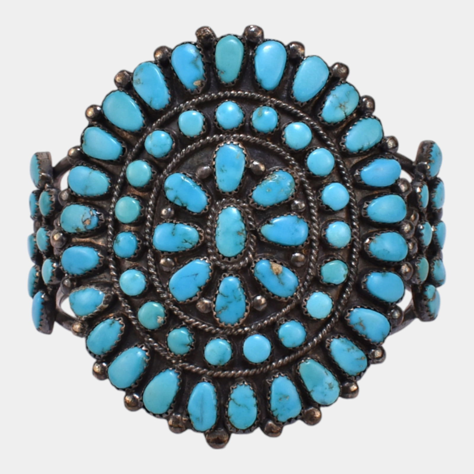 Native American Mid Century Sterling Silver Turquoise Cluster Cuff Bracelet: Boldly ornate and masterfully handcrafted, this Southwestern-style cuff bracelet features an expansive turquoise cluster design with vivid sky-blue stones, set in heavy sterling silver forming a wide,