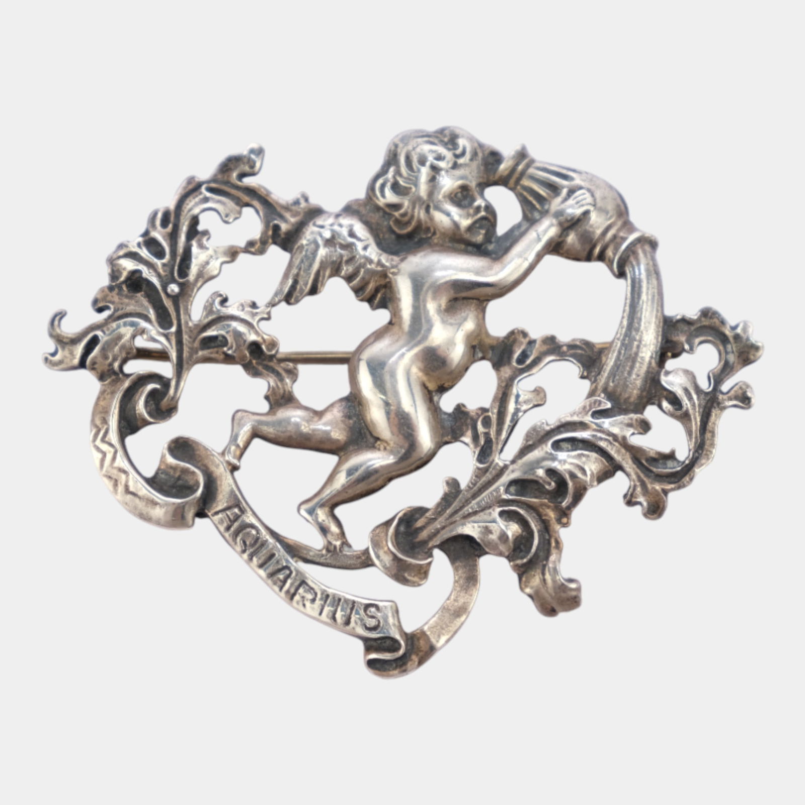 Cini 1960s Sterling Silver Zodiac Series Art Nouveau Aquarius Cherub Brooch: Professional, fast, and affordable in house shipping available for all items. Dramatically sculpted Cini sterling silver brooch depicting a classical cherub pouring water, symbolizing Aquarius. Richl