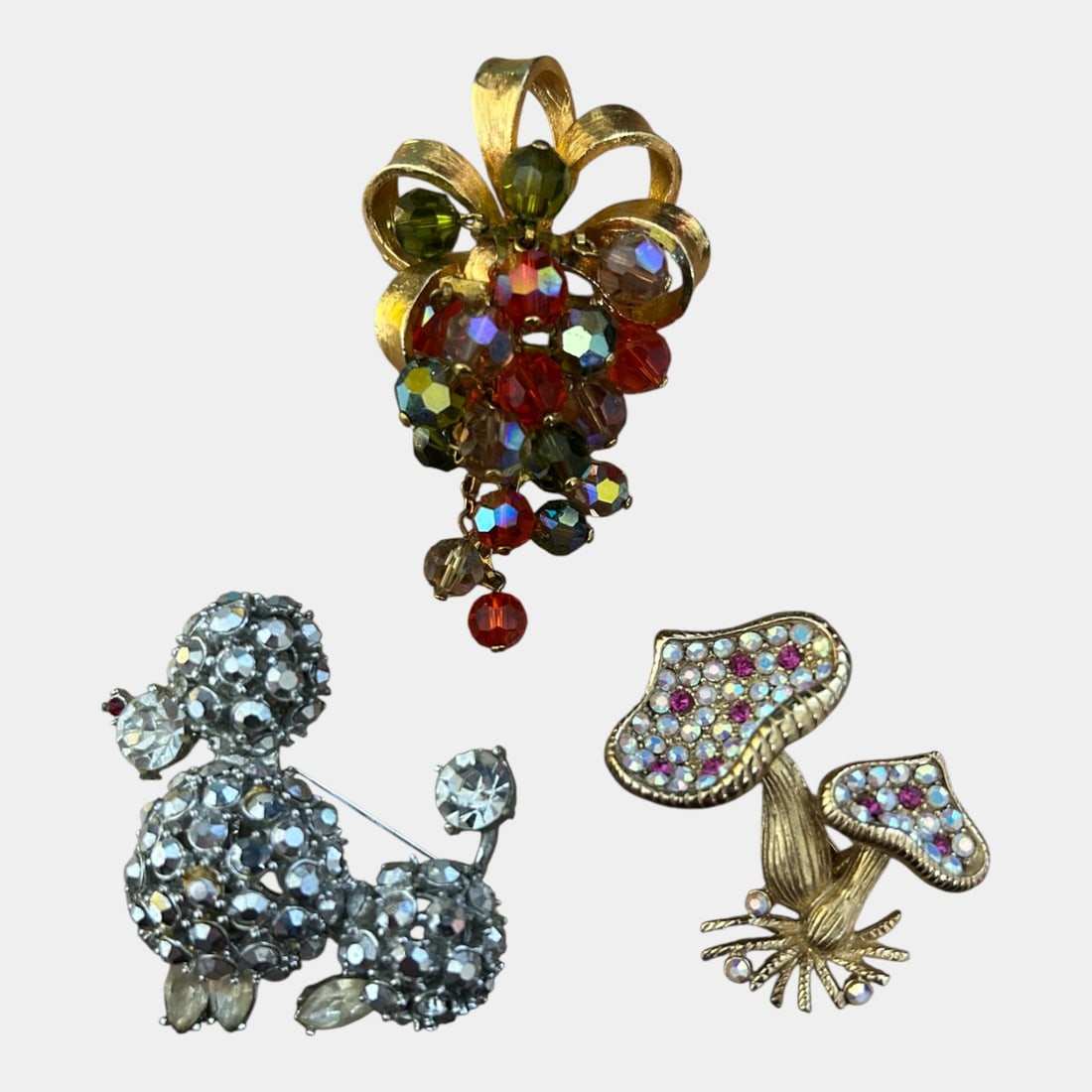 Schreiner Rhinestone Poodle, Hollycraft Mushroom, Grape Trembler Mid Century Brooches: We offer affordable in-house shipping on all items. Schreiner Rhinestone Poodle, Hollycraft Mushroom, Grape Trembler Mid Century Brooches Vividly playful and highly collectible, this Mid-Century Mode