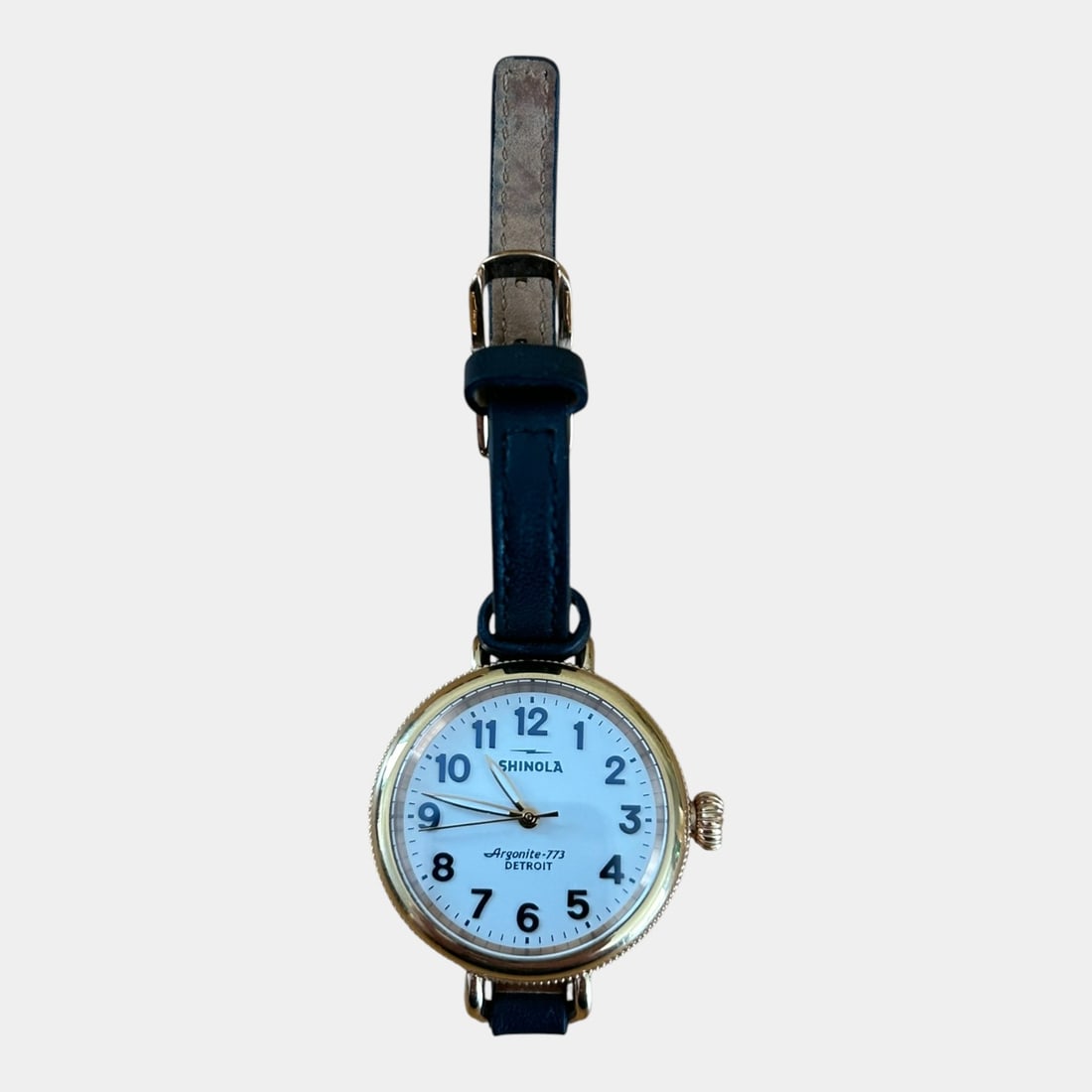 Shinola Detroit 34MM PVD Yellow Gold Tone Case Argonite 773 Leather Band Wristwatch: We offer affordable in-house shipping on all items. Cleanly styled and classically inspired, this contemporary Shinola wristwatch features a polished gold tone round case, crisp white dial with bold