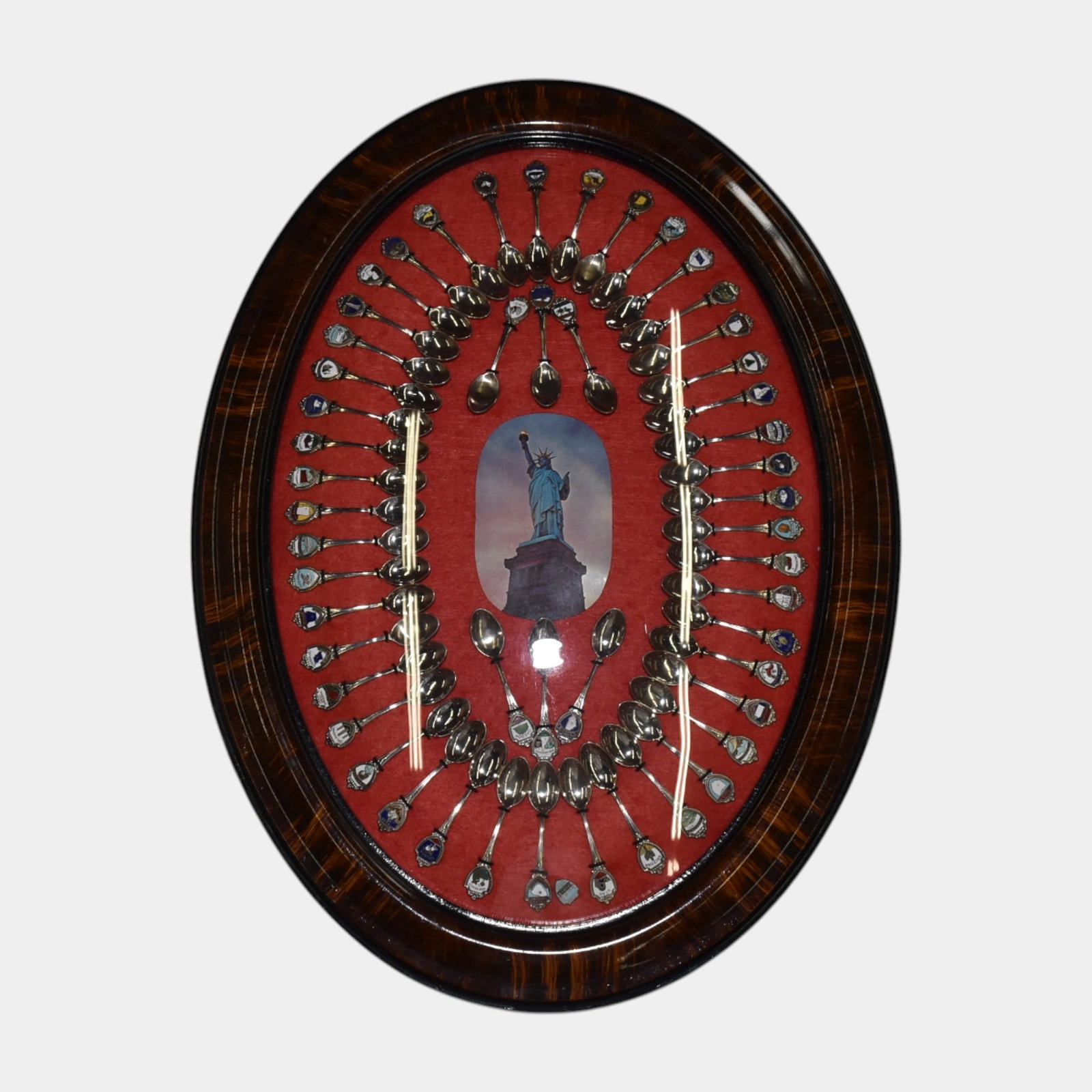 United States Souvenir Spoon Collection In Oval Frame: Professional, fast, and affordable in house shipping available for all items. United States Souvenir Spoon Collection In Oval Frame Excellent condition. Age related wear. 23 1/2" tall and 17" wide.