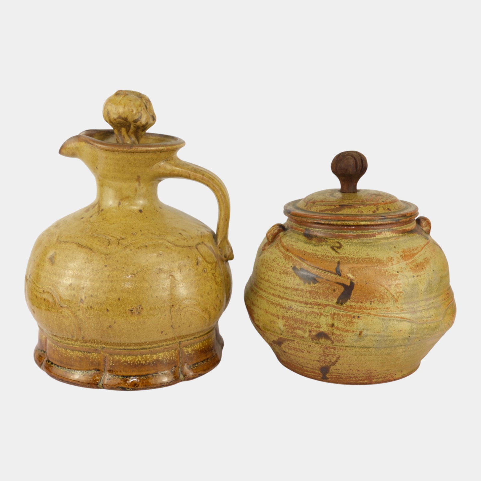John Glick (1938-2017) Plum Tree Pottery Mid Century Pitcher & Lidded Jar: We offer affordable in-house shipping on all items. John Glick (1938-2017) Plum Tree Pottery Mid Century Pitcher & Lidded Jar Pair of John Glick studio pottery pieces featuring a lidded jar and handl