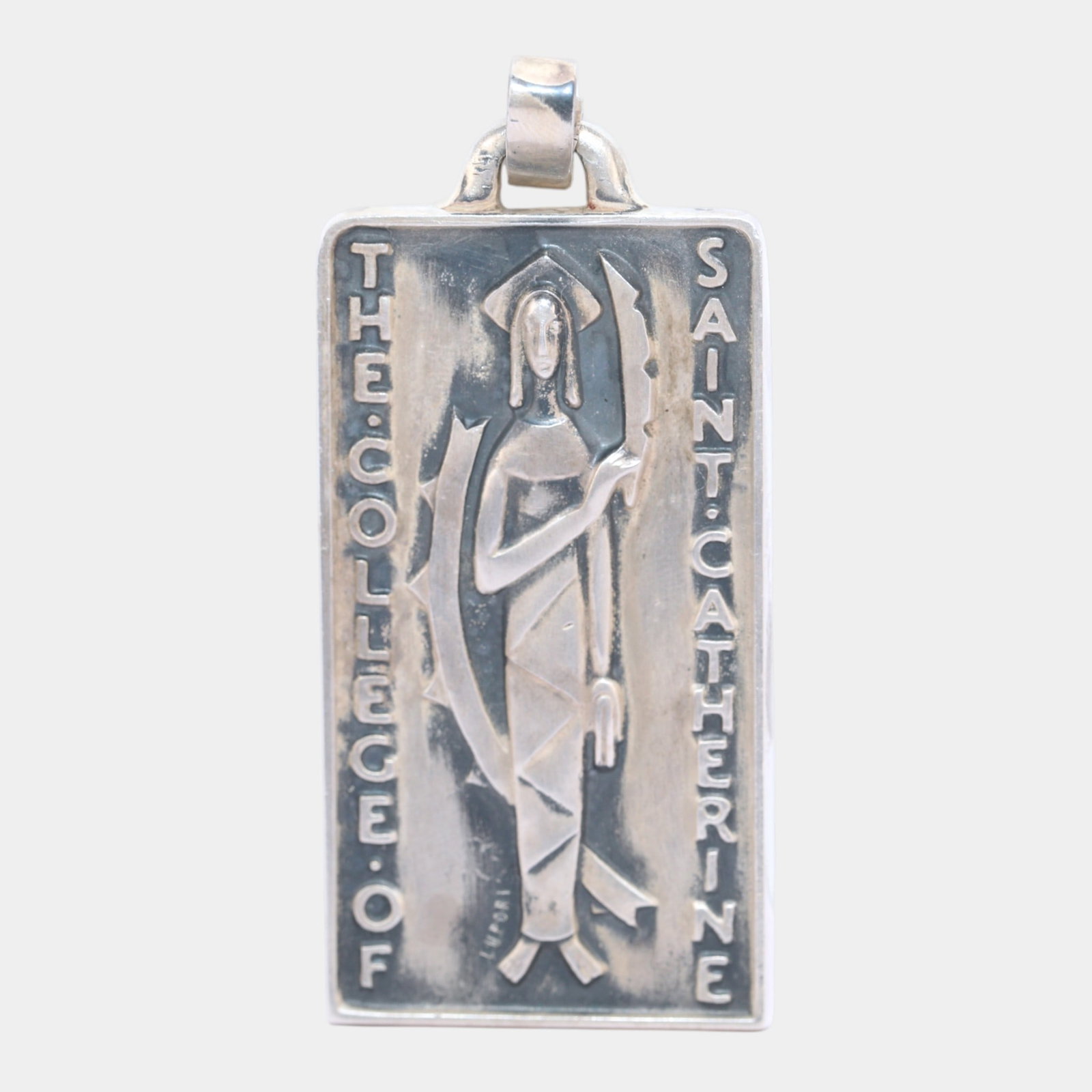 College of St. Catherine 1950s Sterling Silver 925 Mid Century Modern Pendant: Professional, fast, and affordable in house shipping available for all items. This Art Deco sterling silver pendant depicts a stylized figure of Saint Catherine in geometric relief, framed by vertical