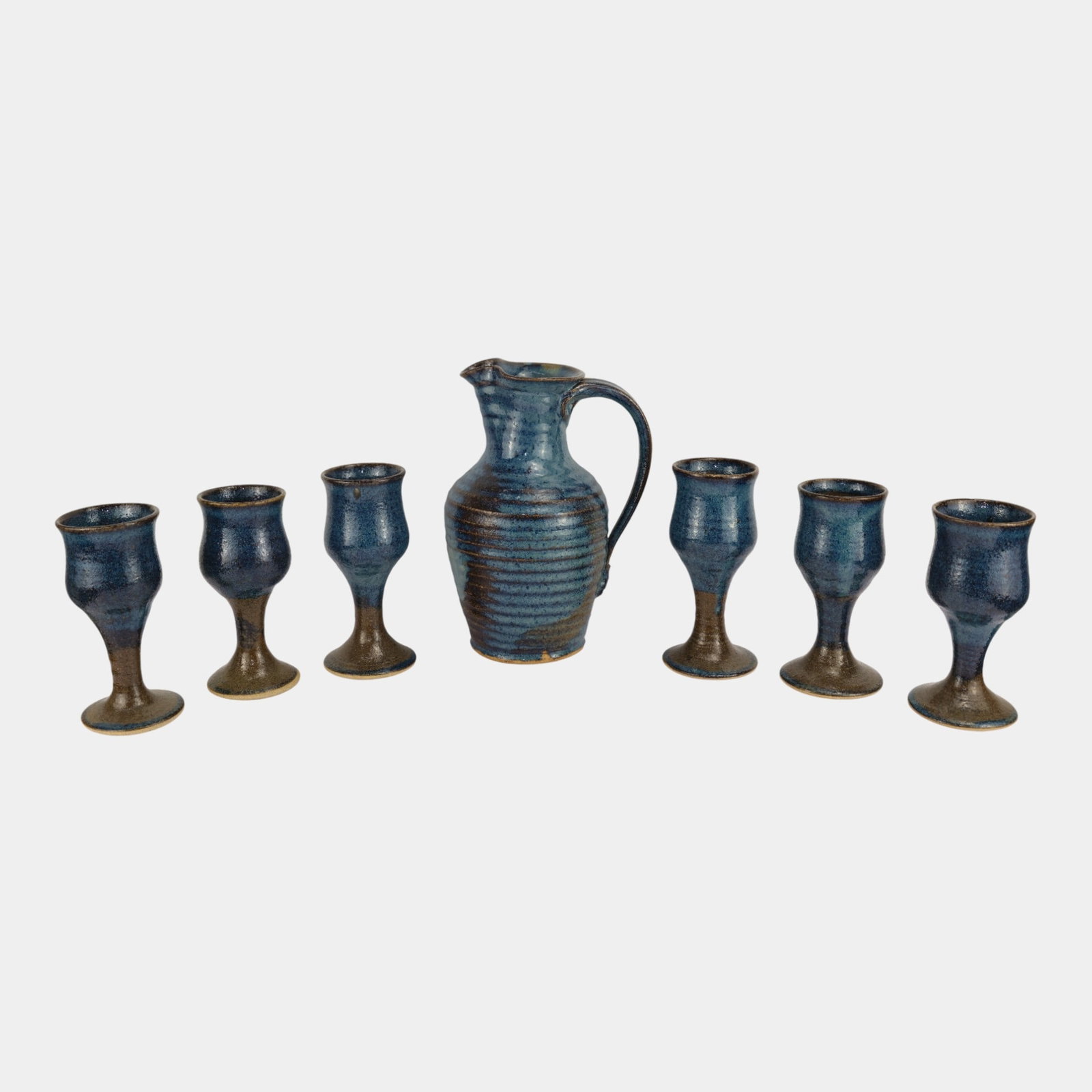 Handcrafted Studio Pottery Mid Century Blue Glazed Ribbed Pitcher & 6 Goblets: We offer affordable in-house shipping on all items. Handcrafted Studio Pottery Mid Century Blue Glazed Ribbed Pitcher & 6 Goblets One cup has an unchipped chip on rim. Age related wear. Pitcher is 9 3