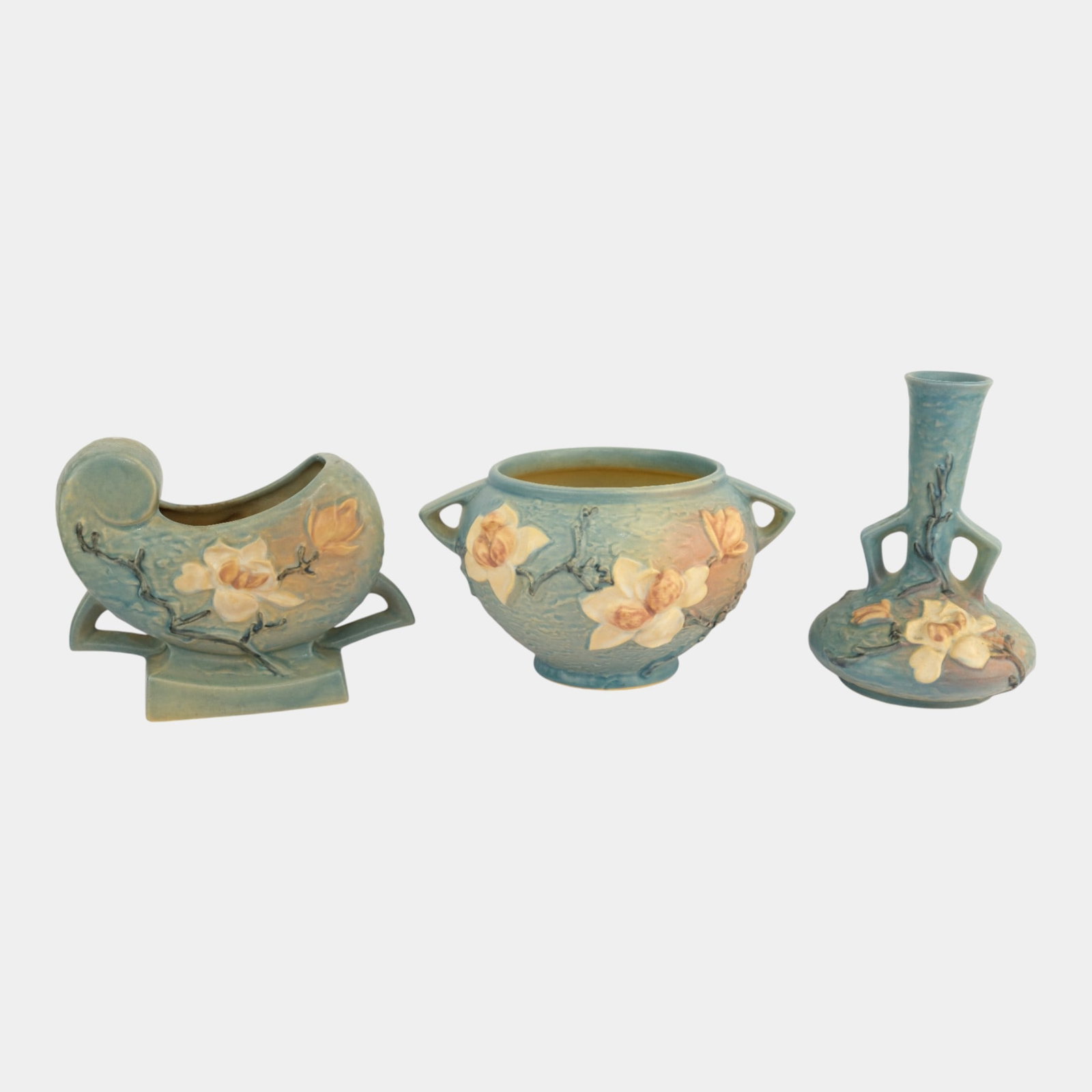 Roseville Magnolia Blue Vases: We offer affordable in-house shipping on all items. Roseville Magnolia Blue Vases Excellent condition. One vase has unchipped chip to bottom. Age related wear. Bottoms marked as shown. Tallest item is
