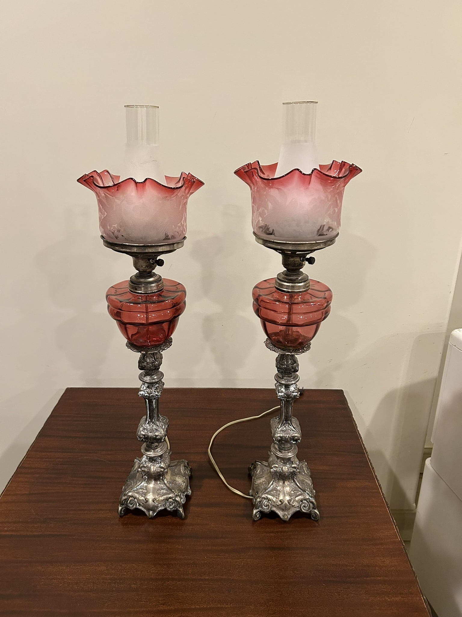 Victorian Style Cranberry Glass And Silver-Tone Metal Electric Lamp Pair: We offer affordable in-house shipping on all items. Victorian Style Cranberry Glass And Silver-Tone Metal Electric Lamp Pair Excellent condition. Age related wear. Lamps are 29" tall to the top of the