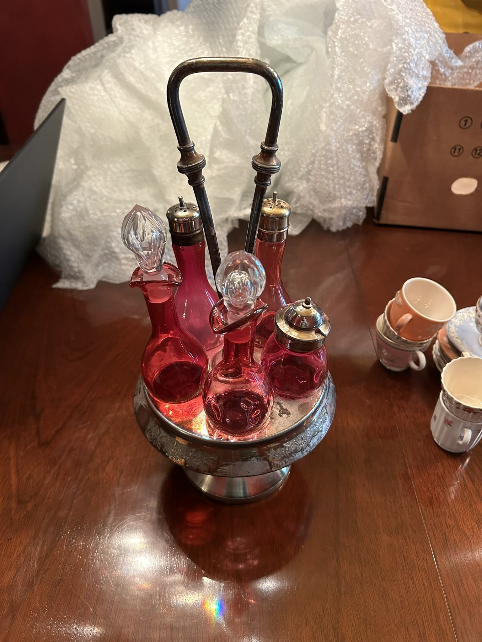 Vintage Cranberry Glass Silver Plate Cruet Condiment Castor Set With Stand: We offer affordable in-house shipping on all items. Vintage Cranberry Glass Silver Plate Cruet Condiment Castor Set With Stand Excellent condition. Age related wear. Set is 15 1/2" tall.