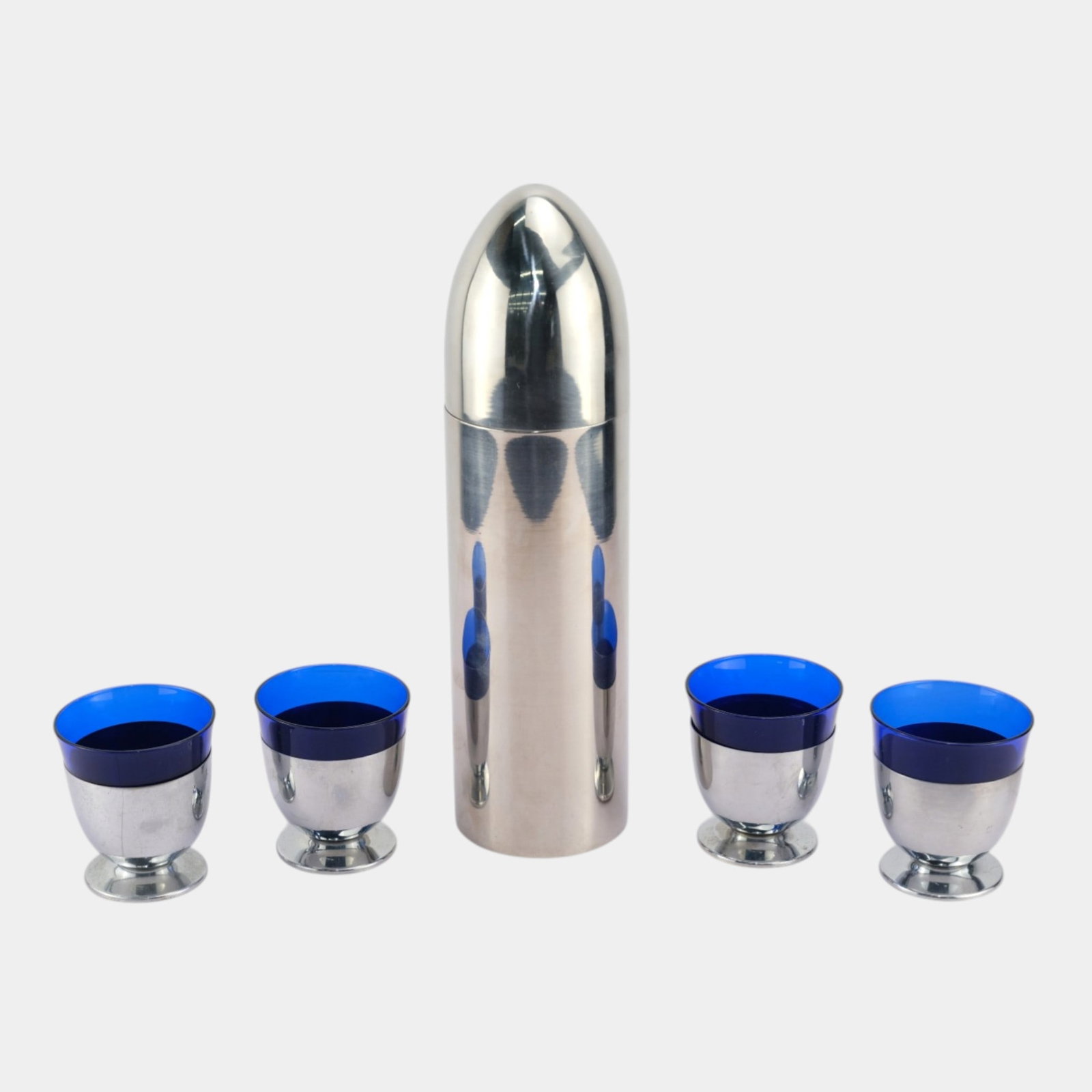 Stainless Steel Silver Bullet Cocktail Shaker With Blue Glass Insert Cups Stainless Base: We offer affordable in-house shipping on all items.For higher resolution images please visit bid.craftedauctions.com Stainless Steel Silver Bullet Cocktail Shaker With Blue Glass Insert Cups Stainless