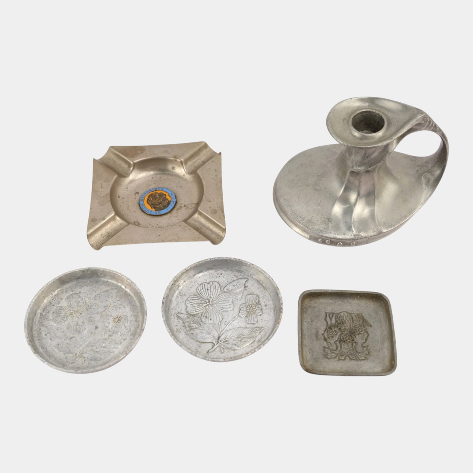 20th Century Silver-Tone Metal Decorated Coasters, Square Dish, Ash Tray, & Chamberstick: We offer affordable in-house shipping on all items.For higher resolution images please visit bid.craftedauctions.com Excellent condition. Age related wear. Bottom marked as shown. Tallest is 3 1/2" ta
