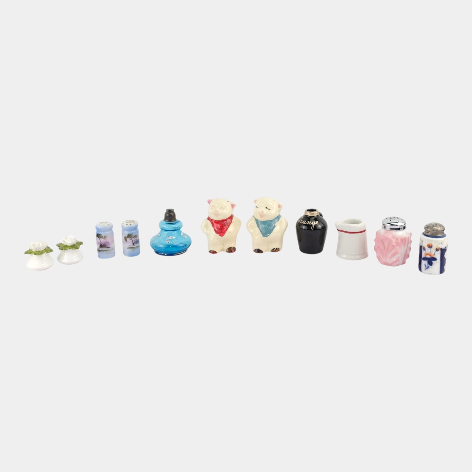 Ansley, Royal Copley, & Other Glass, Porcelain, Pottery Miniatures Shakers And Pitcher: We offer affordable in-house shipping on all items.For higher resolution images please visit bid.craftedauctions.com Excellent condition. Age related wear. Tallest is 3 1/4" tall and 2 3/4" wide.