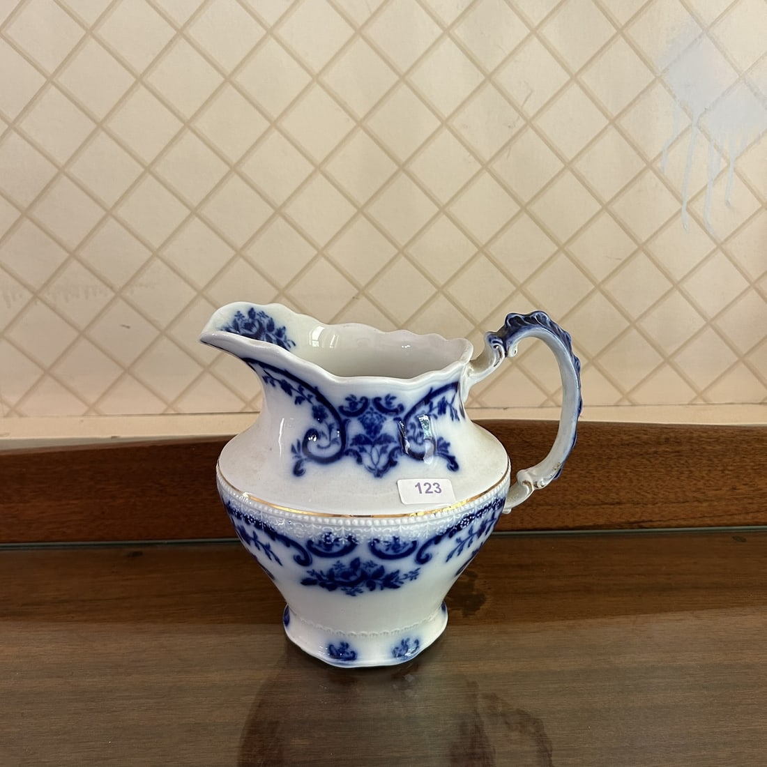 WH Grindley Late 19th Century English Flow Blue Handled Pitcher With Gold Gilt Accent: Professional, fast, and affordable in house shipping available for all items.For higher resolution images please visit www.bid.craftedauctions.com WH Grindley Late 19th Century English Flow Blue Handl