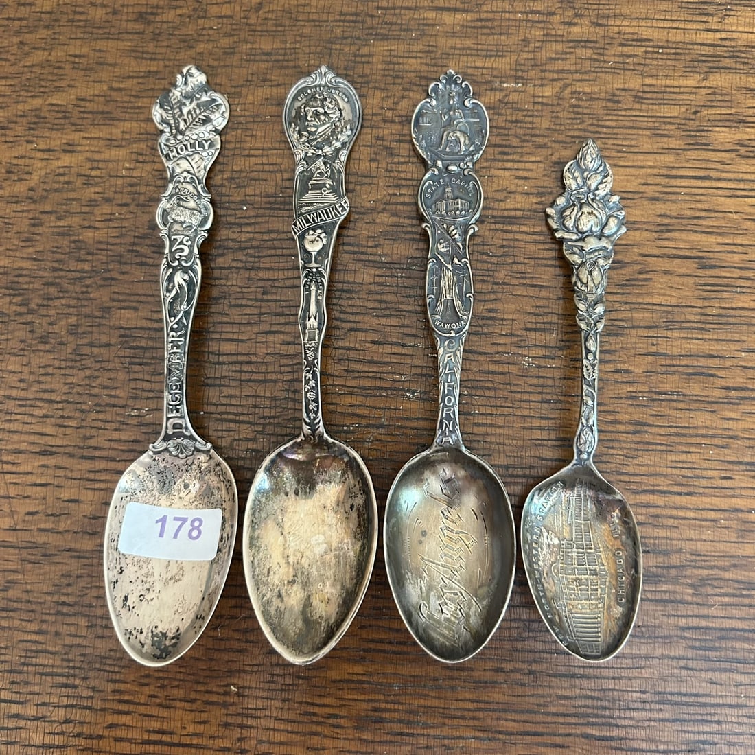 Late 19th Century Sterling Silver Milwaukee, California, Holly, & Chicago Detailed Souvenir Spoons: Professional, fast, and affordable in house shipping available for all items.For higher resolution images please visit www.bid.craftedauctions.com Late 19th Century Sterling Silver Milwaukee, Californ