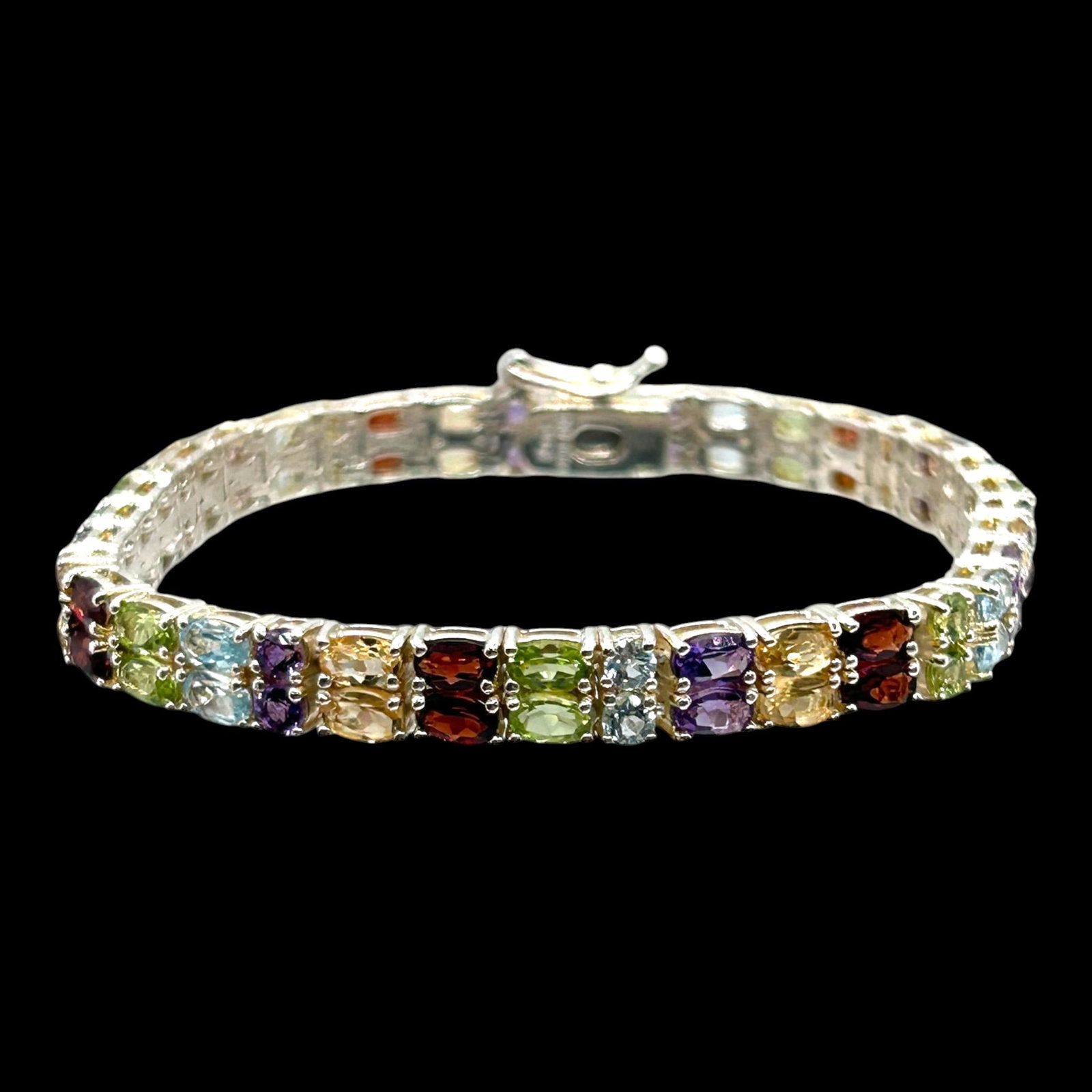 Sterling Silver Multi Gemstone Tennis Bracelet With Amethyst Garnet Peridot Citrine & Blue Topaz: Professional, fast, and affordable in house shipping available for all items.For higher resolution images please visit bid.craftedauctions.com Brilliantly crafted, this sterling silver tennis bracelet