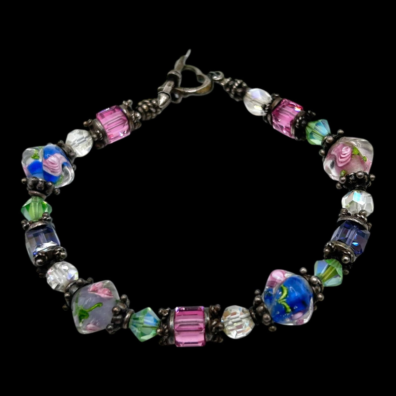 Sterling Silver Lampwork Art Glass Bead Bracelet With Floral Crystal & Millefiori Beads: Professional, fast, and affordable in house shipping available for all items.For higher resolution images please visit bid.craftedauctions.com Colorfully handcrafted, this sterling silver bracelet fea