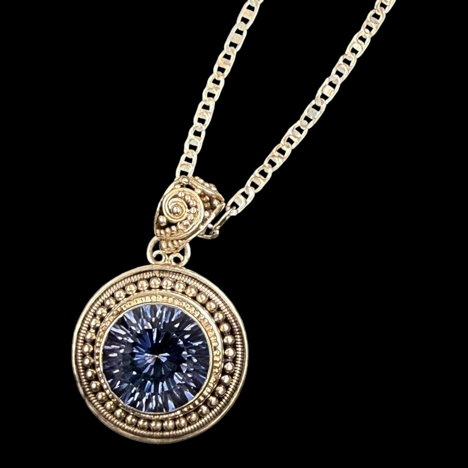 Sterling Silver Faceted Iolite Beaded Halo Pendant Necklace With Decorative Ornate Setting: Professional, fast, and affordable in house shipping available for all items.For higher resolution images please visit bid.craftedauctions.com Elegantly crafted, this sterling silver pendant necklace 