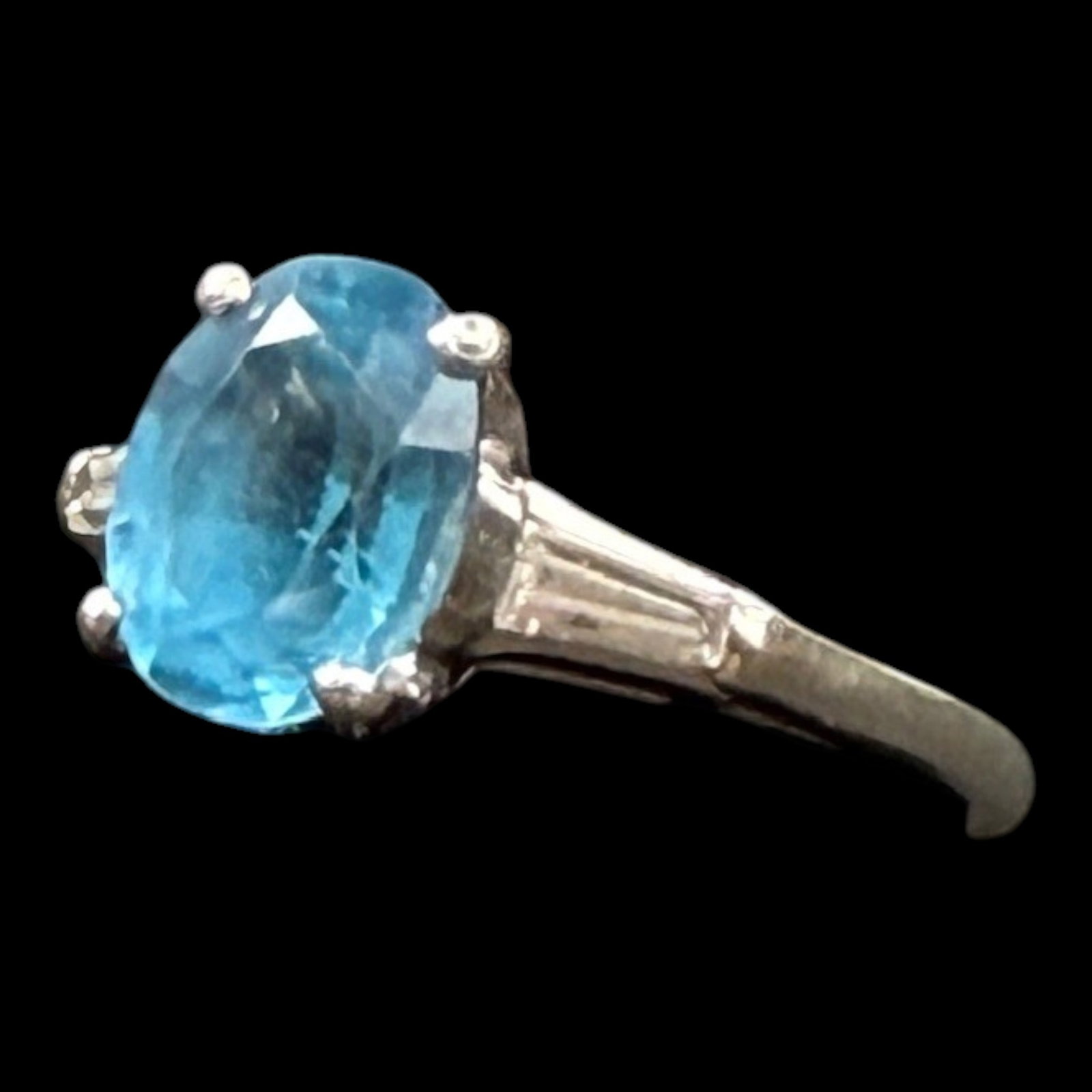 10% Platinum Blue Topaz Solitaire Ring With Tapered Baguette Accent Shoulders Design: Professional, fast, and affordable in house shipping available for all items.For higher resolution images please visit bid.craftedauctions.com Elegantly styled, this 10% platinum ring features an oval