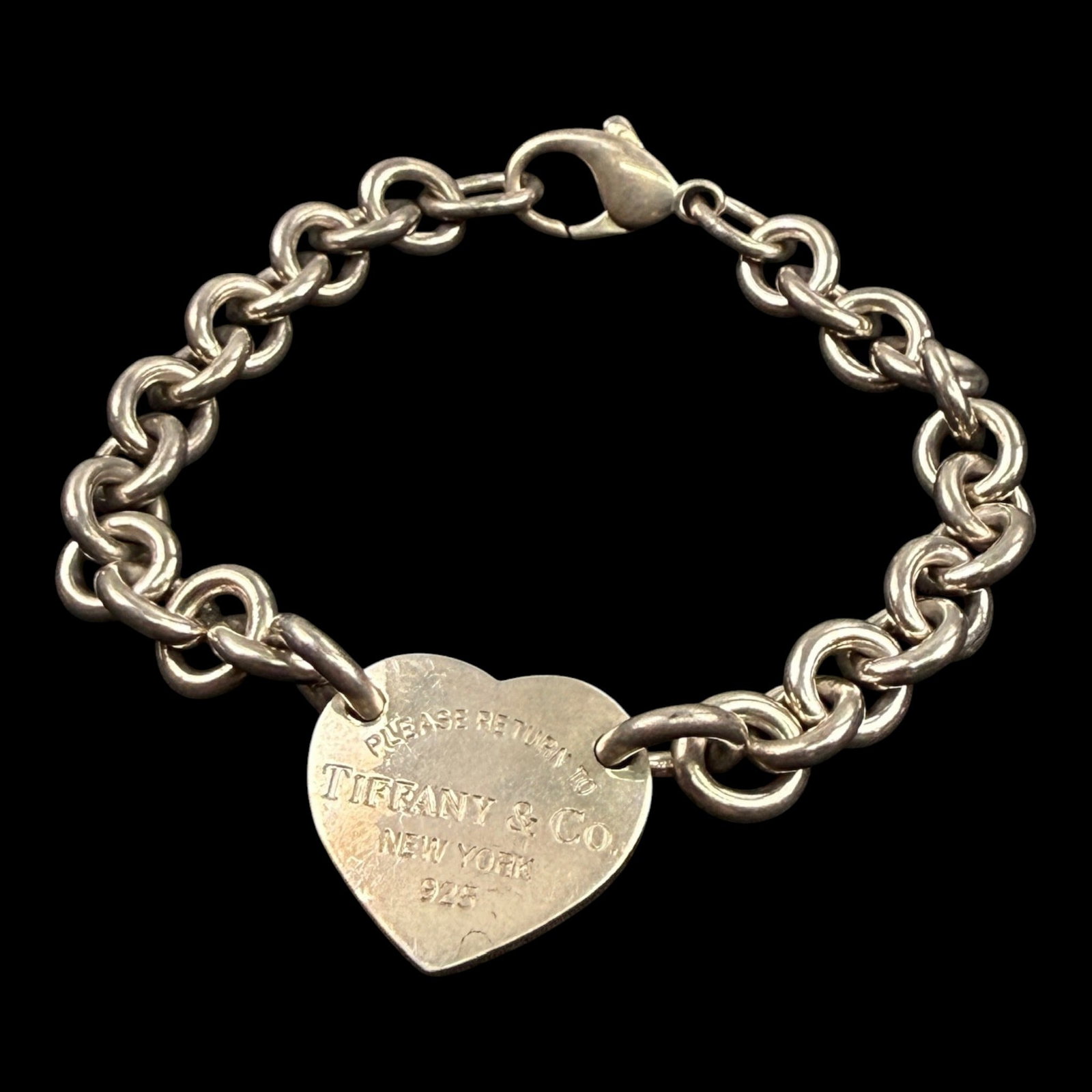 Tiffany & Co. New York Sterling Silver 925 "Please Return To" Heart Tag Link Charm Bracelet: Professional, fast, and affordable in house shipping available for all items.For higher resolution images please visit bid.craftedauctions.com Iconically styled, this Tiffany & Co. Return to Tiffany s