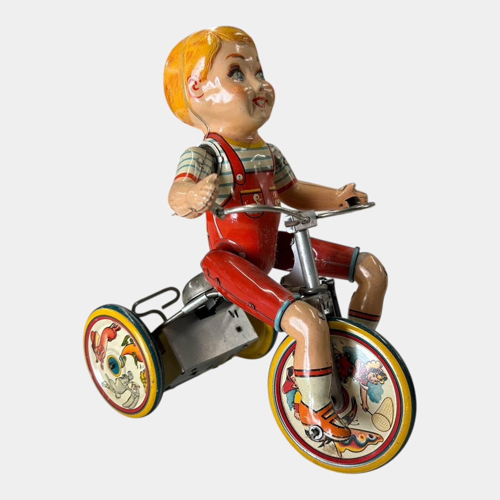 Unique Art MFG Co. 1930s Tin Lithographed Kiddy Cyclist Wind-Up Toy: Professional, fast, and affordable in house shipping available for all items. For higher resolution images please visit bid.craftedauctions.com Unique Art MFG Co. 1930s Tin Lithographed Kiddy Cyclist 