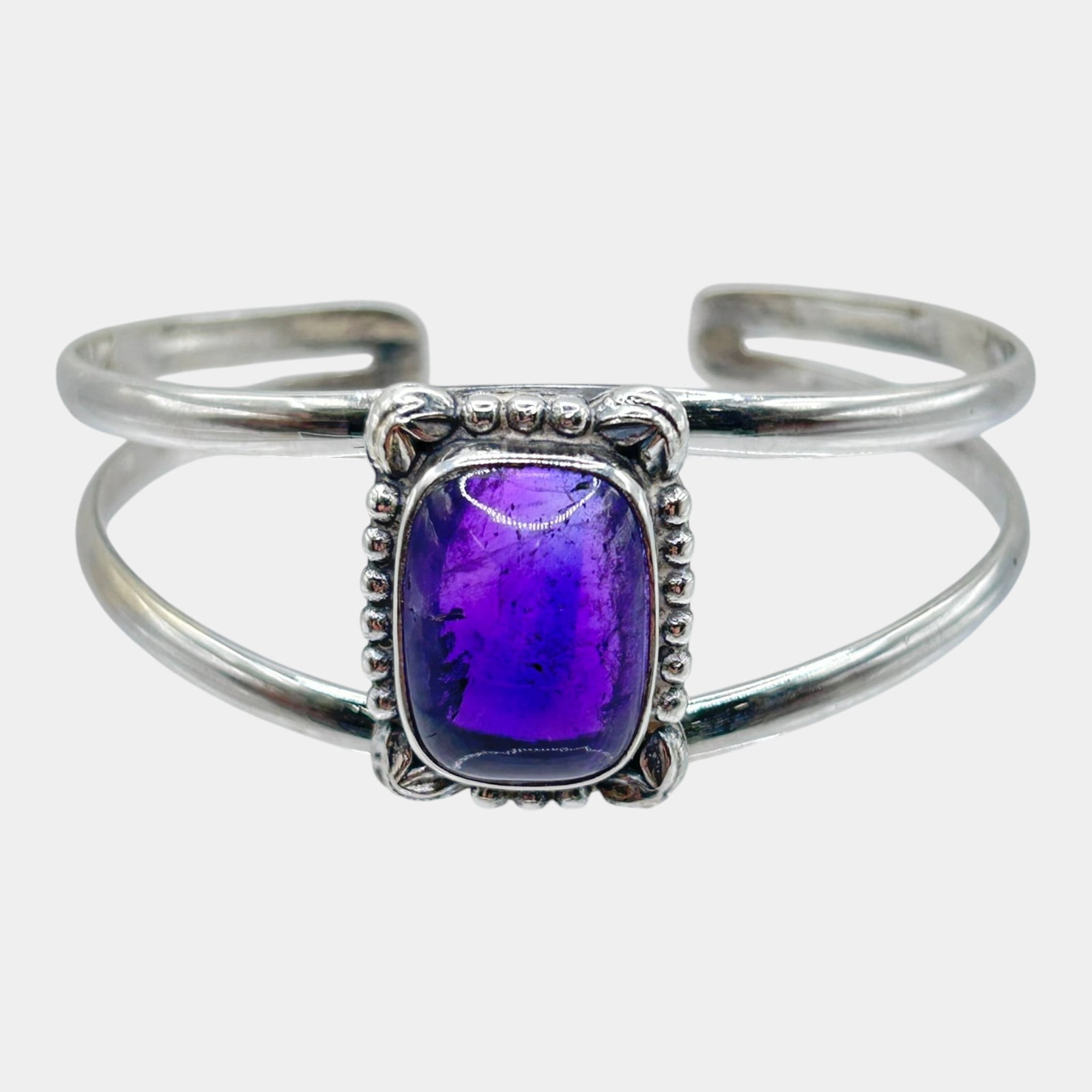 Sterling Silver Purple Amethyst Cabochon Beaded Frame Design Open Cuff Bracelet: Professional, fast, and affordable in house shipping available for all items. For higher resolution images please visit bid.craftedauctions.com Boldly elegant, this sterling silver open cuff bracelet 