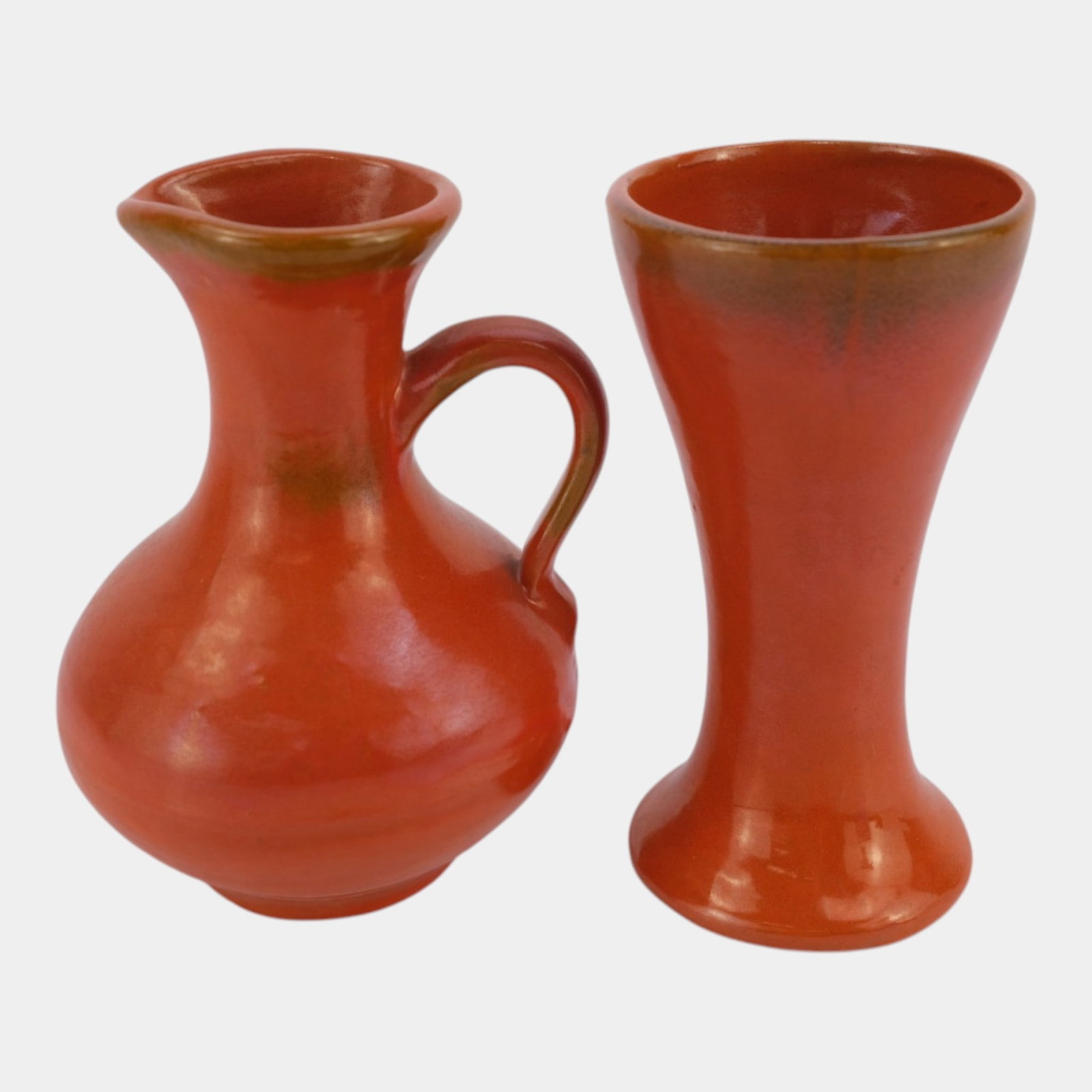 Catalina Island Art Pottery Toyon Red Flared Trumpet Vase And Handled Pitcher: Professional, fast, and affordable in house shipping available for all items. For higher resolution images please visit bid.craftedauctions.com Catalina Island Art Pottery Toyon Red Flared Trumpet Vas
