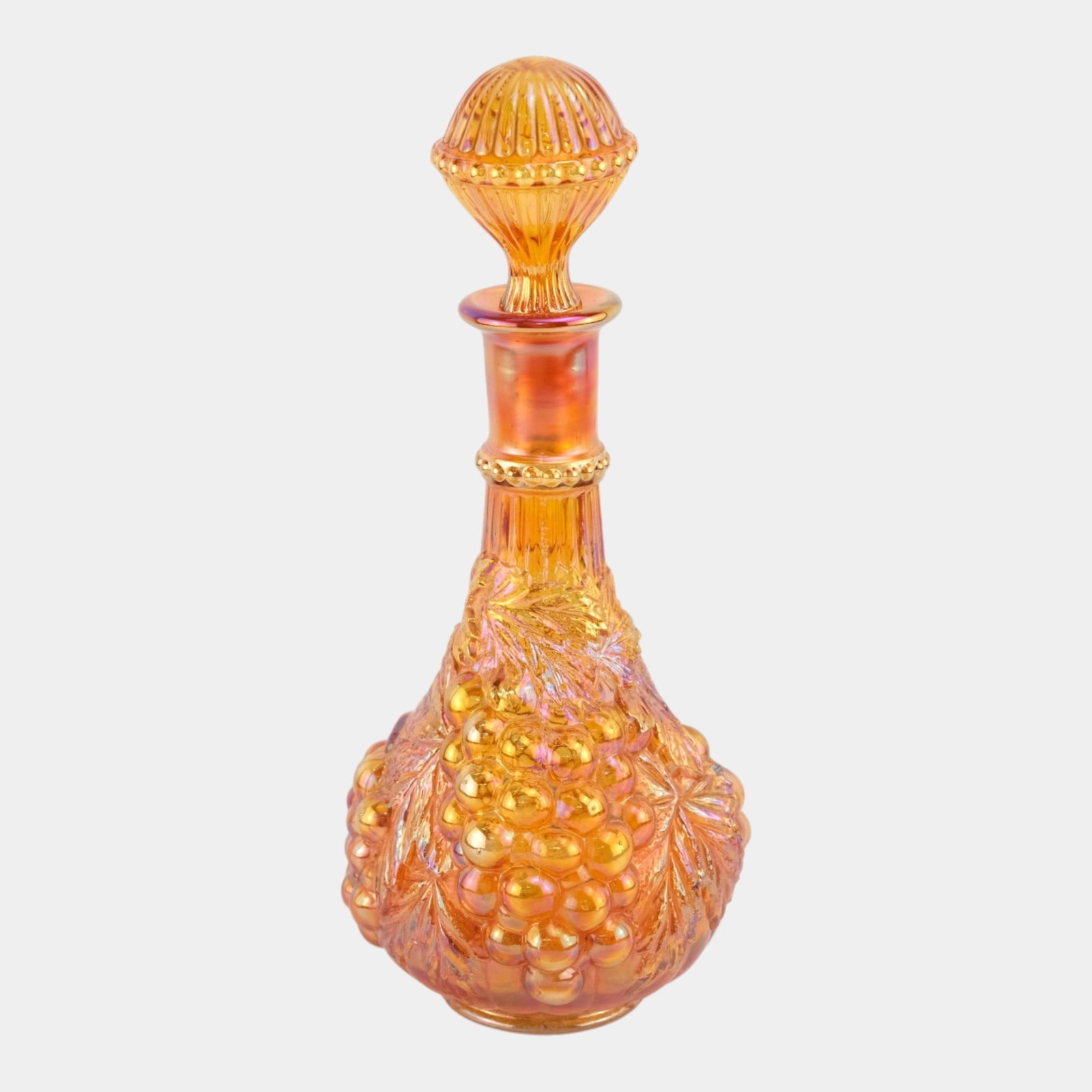 Imperial Glass Company Marigold Iridescent Carnival Glass Grape & Vine Decanter: Professional, fast, and affordable in house shipping available for all items. For higher resolution images please visit bid.craftedauctions.com Imperial Glass Company Marigold Iridescent Carnival Glas