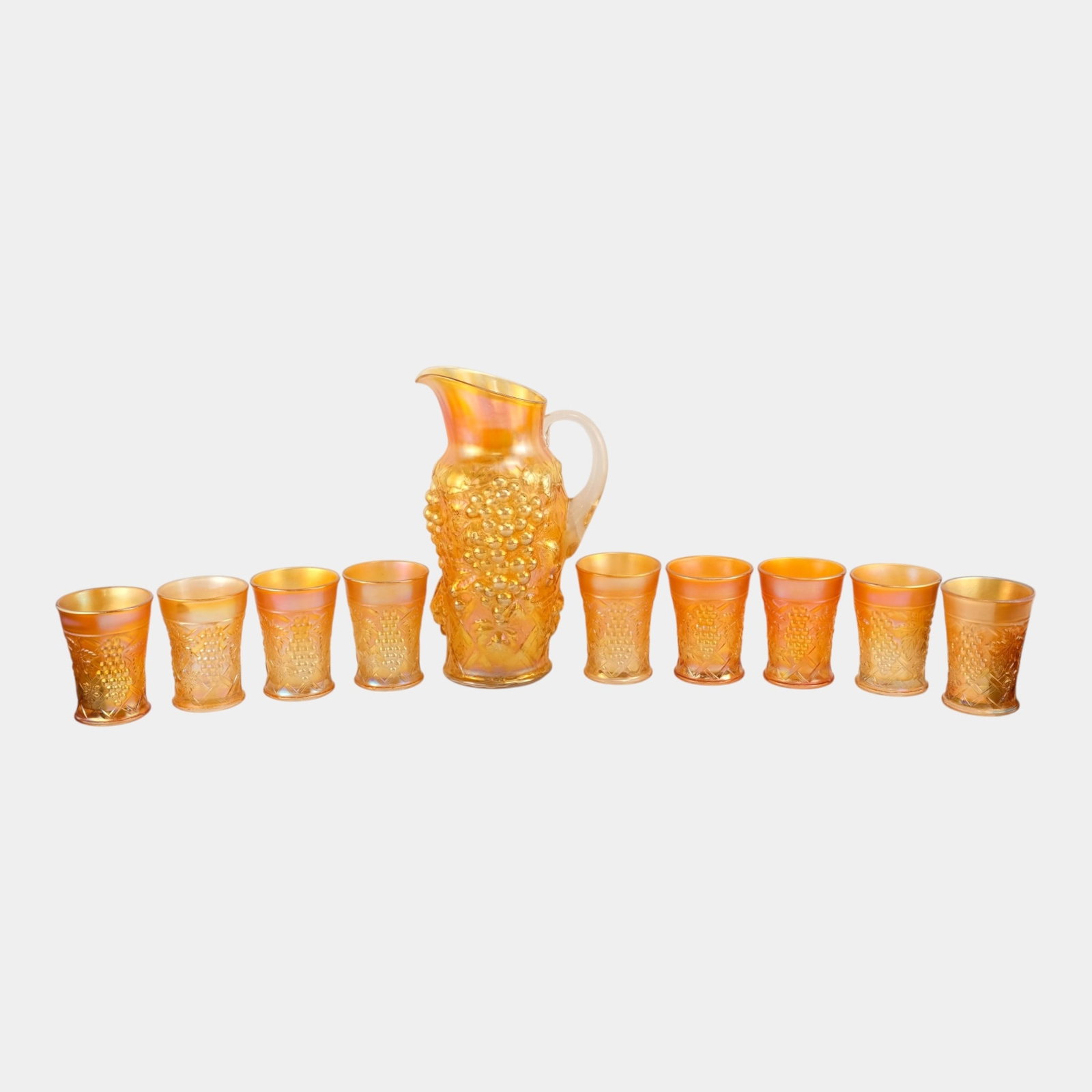 Northwood Marigold Iridescent Carnival Glass Grape Arbor Water Pitcher With 9 Matching Tumblers: Professional, fast, and affordable in house shipping available for all items. For higher resolution images please visit bid.craftedauctions.com Northwood Marigold Iridescent Carnival Glass Grape Arbor