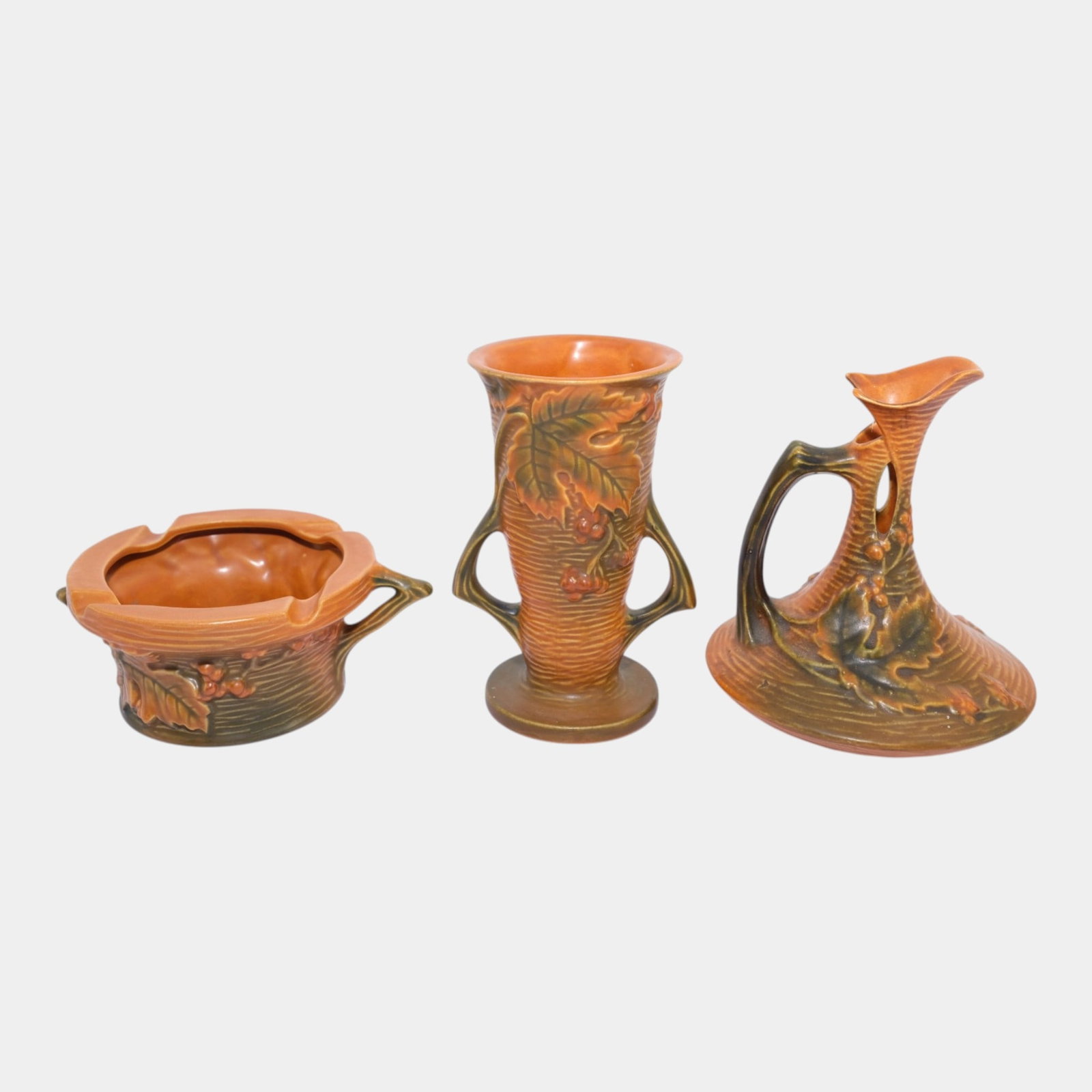 Roseville Bushberry Russet 1941 Art Pottery Ewer, Bowl, & Vase: Professional, fast, and affordable in house shipping available for all items. For higher resolution images please visit bid.craftedauctions.com Roseville Bushberry Russet 1941 Art Pottery Ewer, Bowl, 