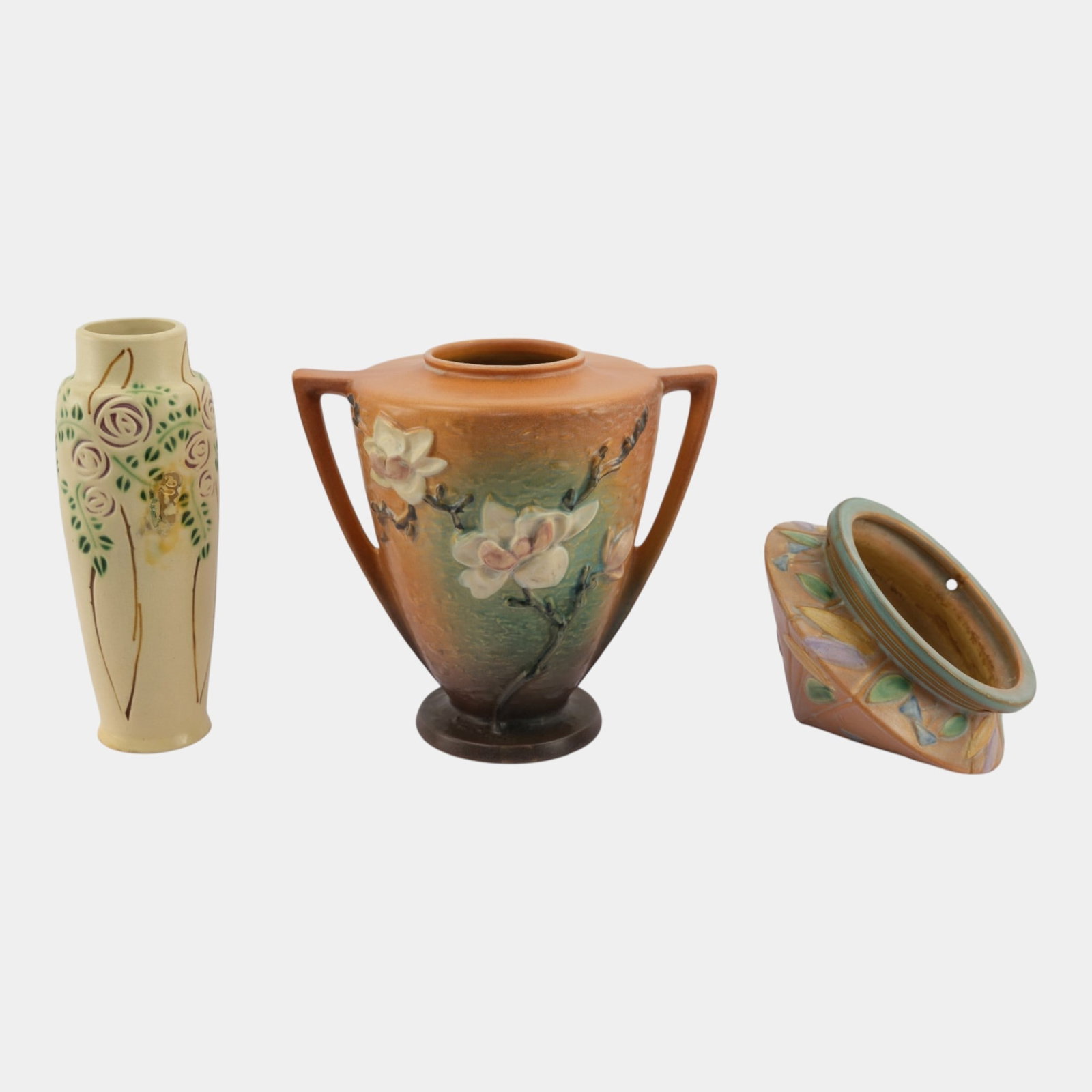 Roseville Magnolia, Futura, & Velmoss Scroll Art Pottery Vases And Hanging Basket: Professional, fast, and affordable in house shipping available for all items. For higher resolution images please visit bid.craftedauctions.com Roseville Magnolia, Futura, & Velmoss Scroll Art Pot