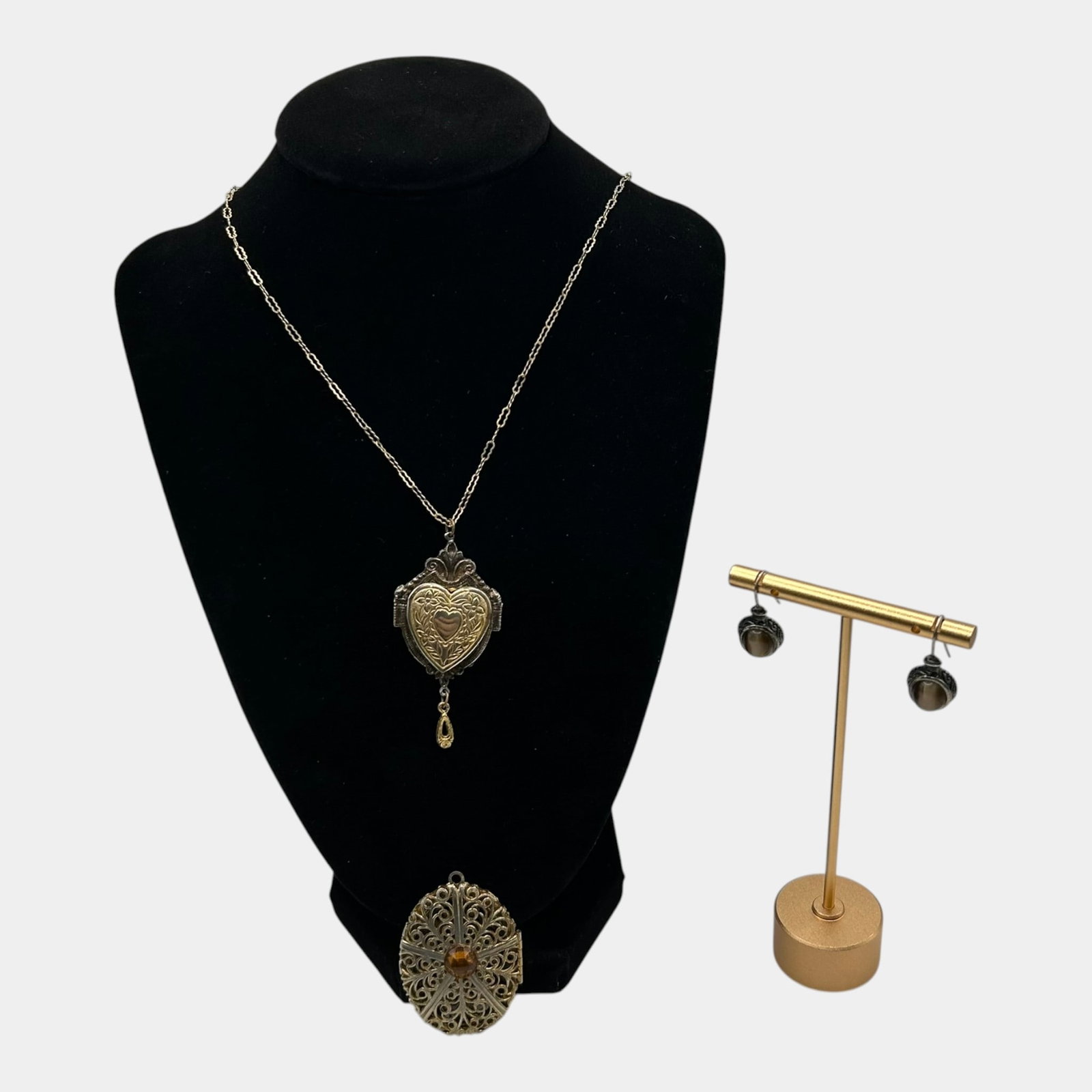Vintage Jewelry Lot With Ornate Heart Locket Pendant, Scrollwork Pendant, And Dangle Earrings: Professional, fast, and affordable in house shipping available for all items. For higher resolution images please visit bid.craftedauctions.com Excellent condition. Age related wear. Pendant is 2"long