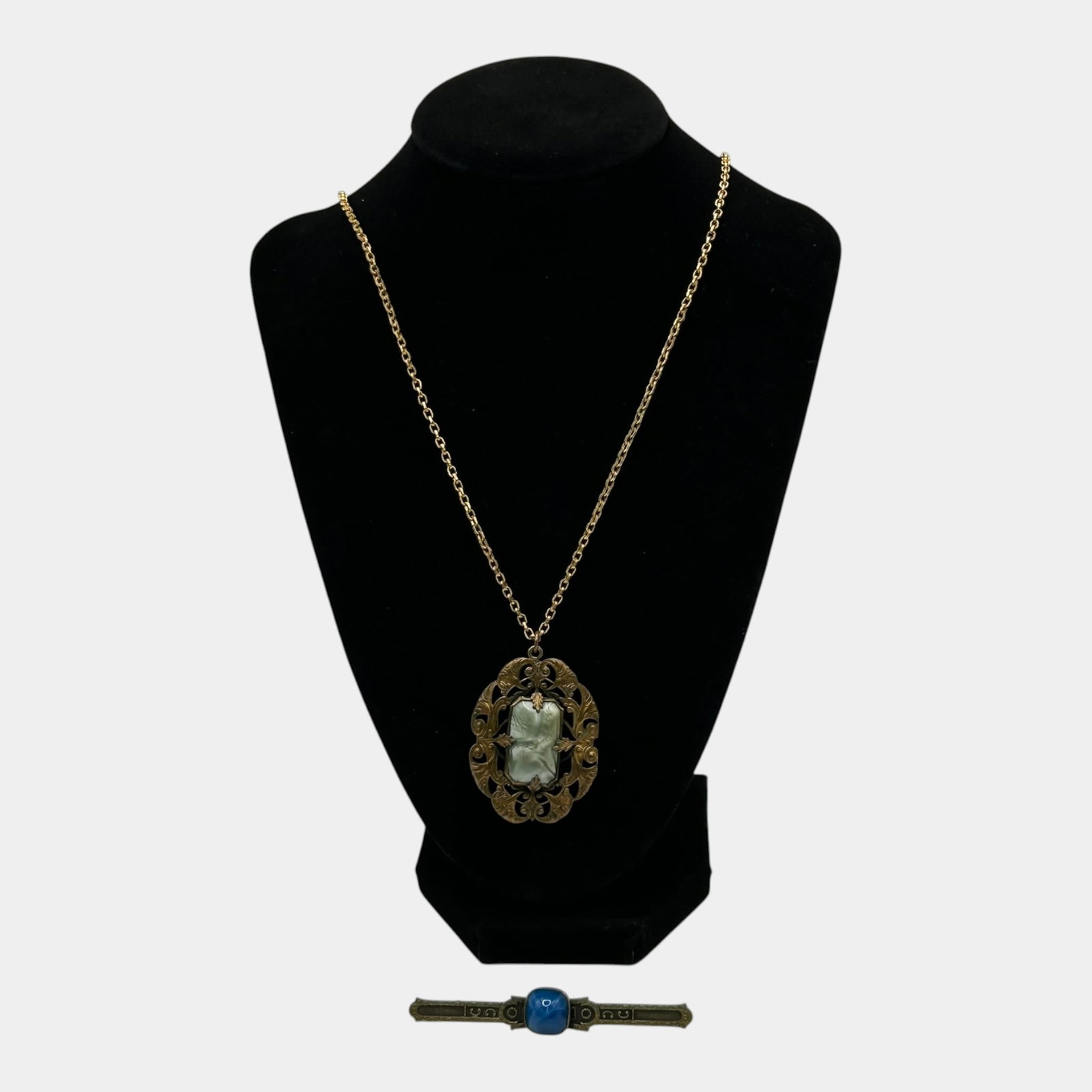 Vintage Gold Tone Pendant Necklace And Egyptian Revival Blue Cabochon Brooch Lot: Professional, fast, and affordable in house shipping available for all items. For higher resolution images please visit bid.craftedauctions.com Excellent condition. Age related wear. Brooch is 3" wide