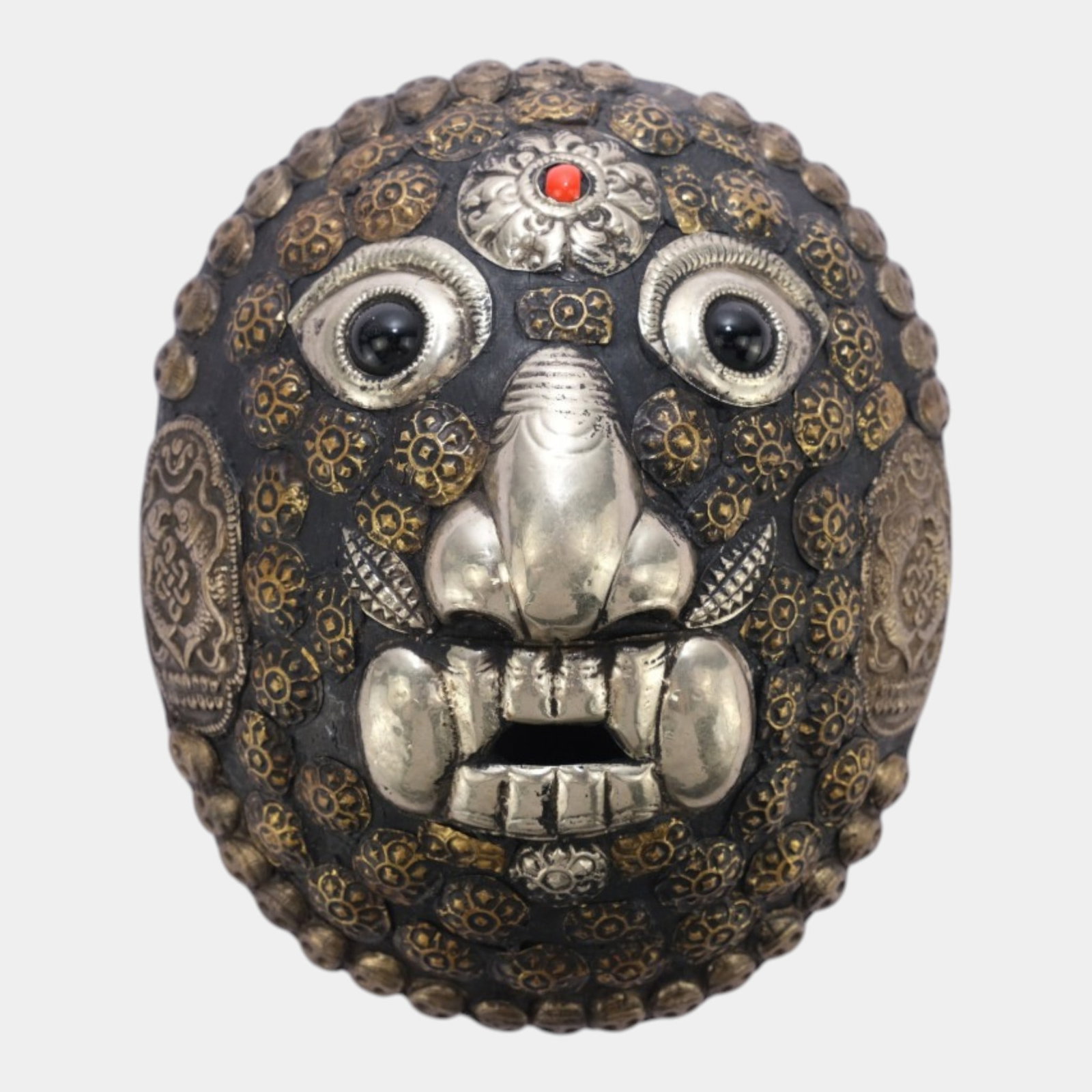Tibetan Repousse Silvered Metal & Wood Kapala Mask With Coral Accent Wall Hanging: Professional, fast, and affordable in house shipping available for all items. For higher resolution images please visit bid.craftedauctions.com Tibetan Repousse Silvered Metal & Wood Kapala Mask With 