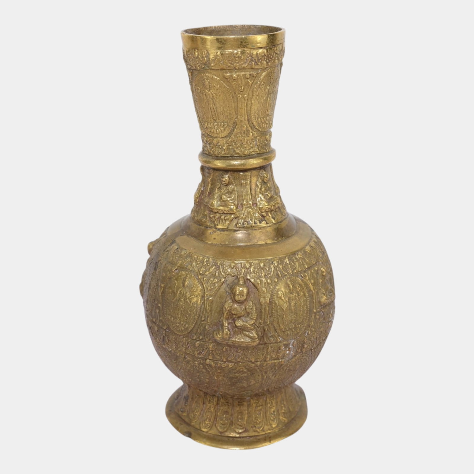 Brass Buddha Relief Bottle Form Vase With Intricate Figural And Floral Decoration: Professional, fast, and affordable in house shipping available for all items. For higher resolution images please visit bid.craftedauctions.com Brass Buddha Relief Bottle Form Vase With Intricate Figu