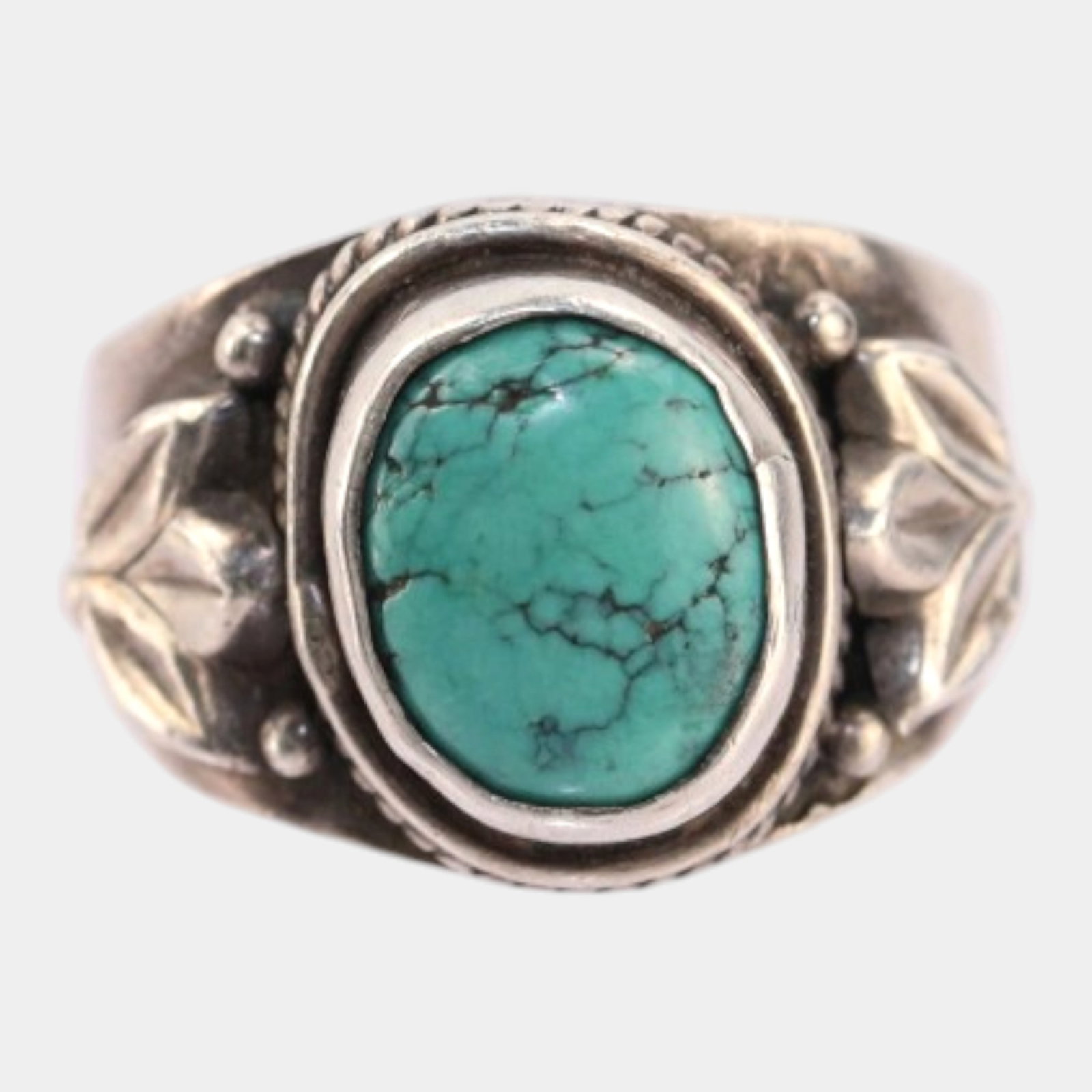 Sterling Silver Turquoise Cabochon Ring With Floral Leaf Accents And Braided Bezel: Professional, fast, and affordable in house shipping available for all items. For higher resolution images please visit bid.craftedauctions.com Boldly detailed and Southwestern inspired, this vintage 