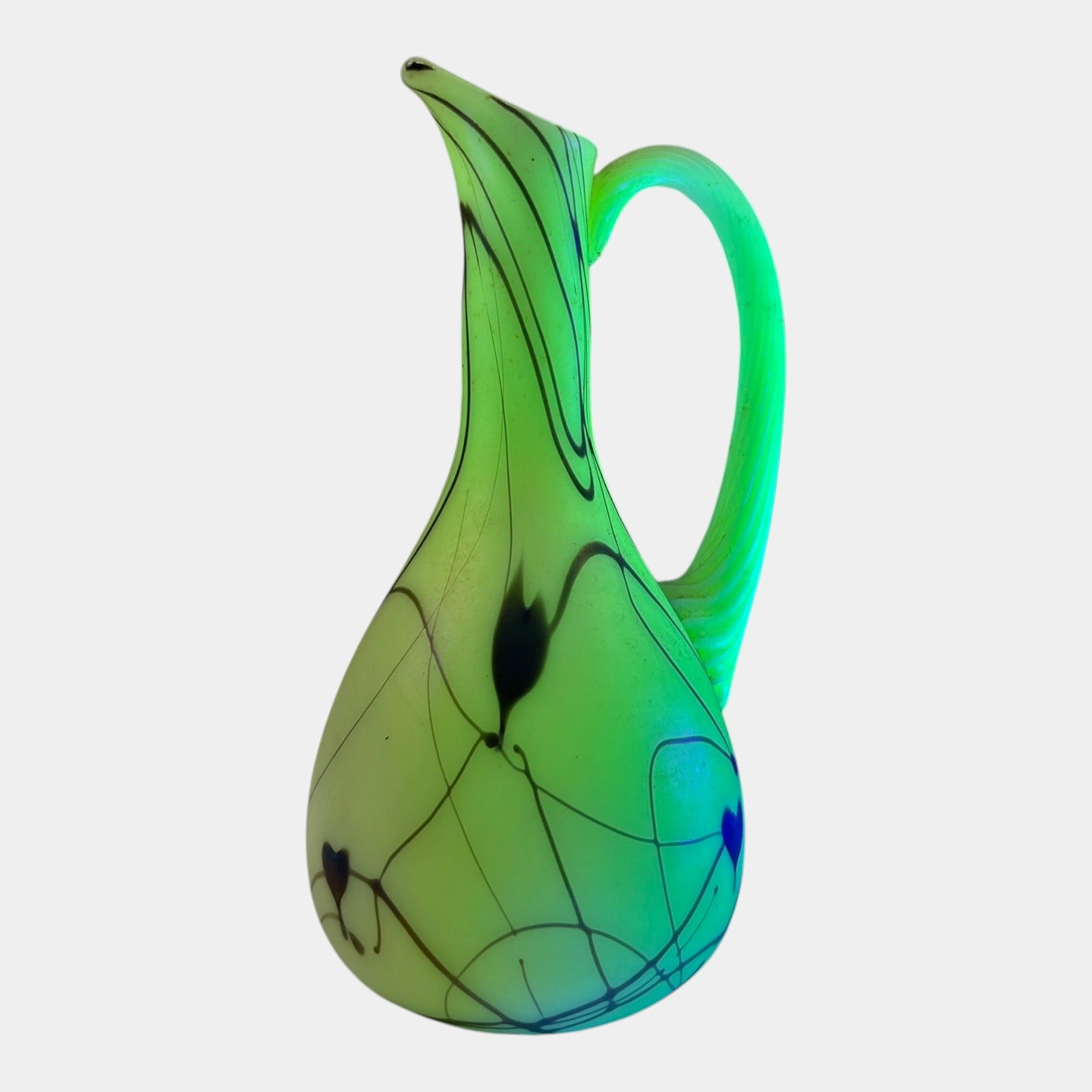 Fenton Art Glass Co. 1976 Custard "Hanging Heart" Uranium Glass Handled Pitcher: Professional, fast, and affordable in house shipping available for all items. For higher resolution images please visit bid.craftedauctions.com Fenton Art Glass Co. 1976 Custard "Hanging Heart" Uraniu
