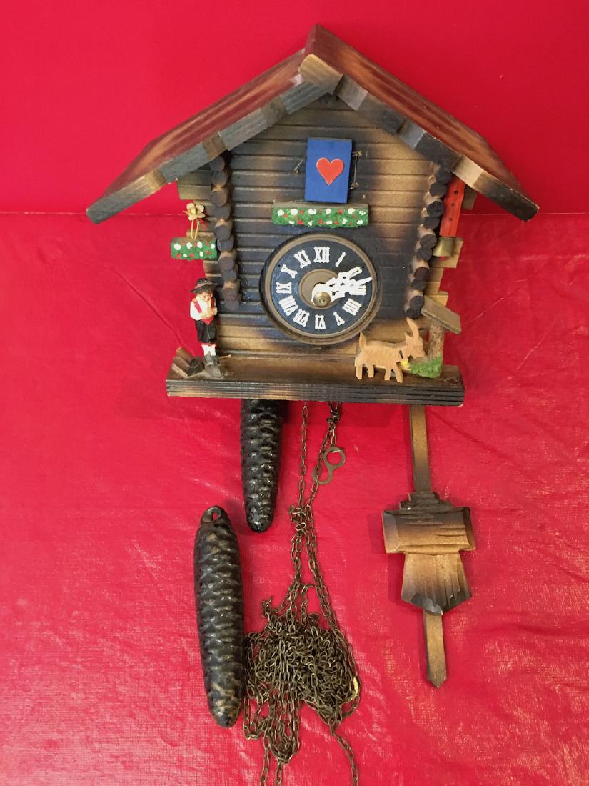 Cuckoo Clock: Cuckoo clock with boy and goat figures, goat needs to be reglued. Measures aproximatly 7 and 1/2 in. tall by 7 in. wide